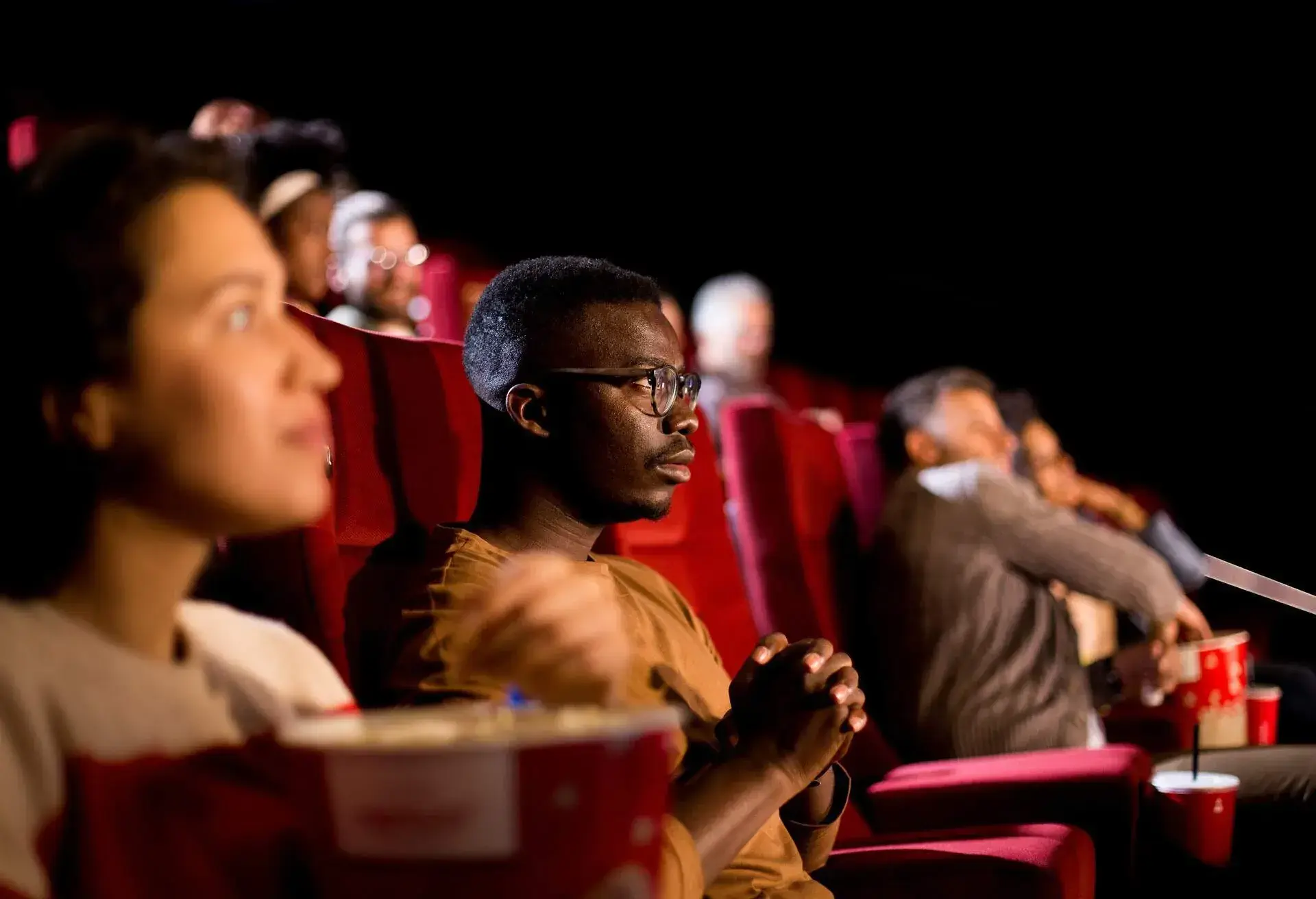 THEME_CINEMA_FILM_PEOPLE_EATING_POPCORN_GettyImages-1340577529