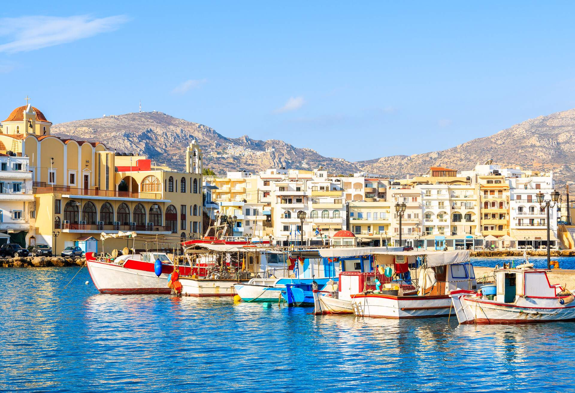 Boats in beautiful Pigadia fishing port with mountains in background, Karpathos island, Greece; Shutterstock ID 1408981349
