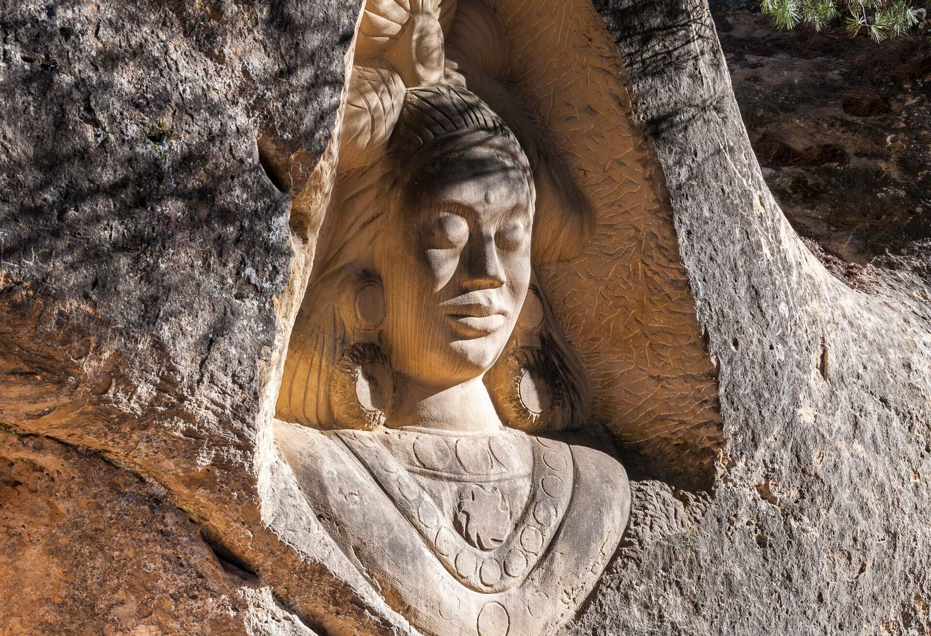 Sculptures carved on sandstones in the Ruta de las Caras, Route of the Faces, a hiking route at the shore of Buendia Reservoir, Cuenca, Spain.