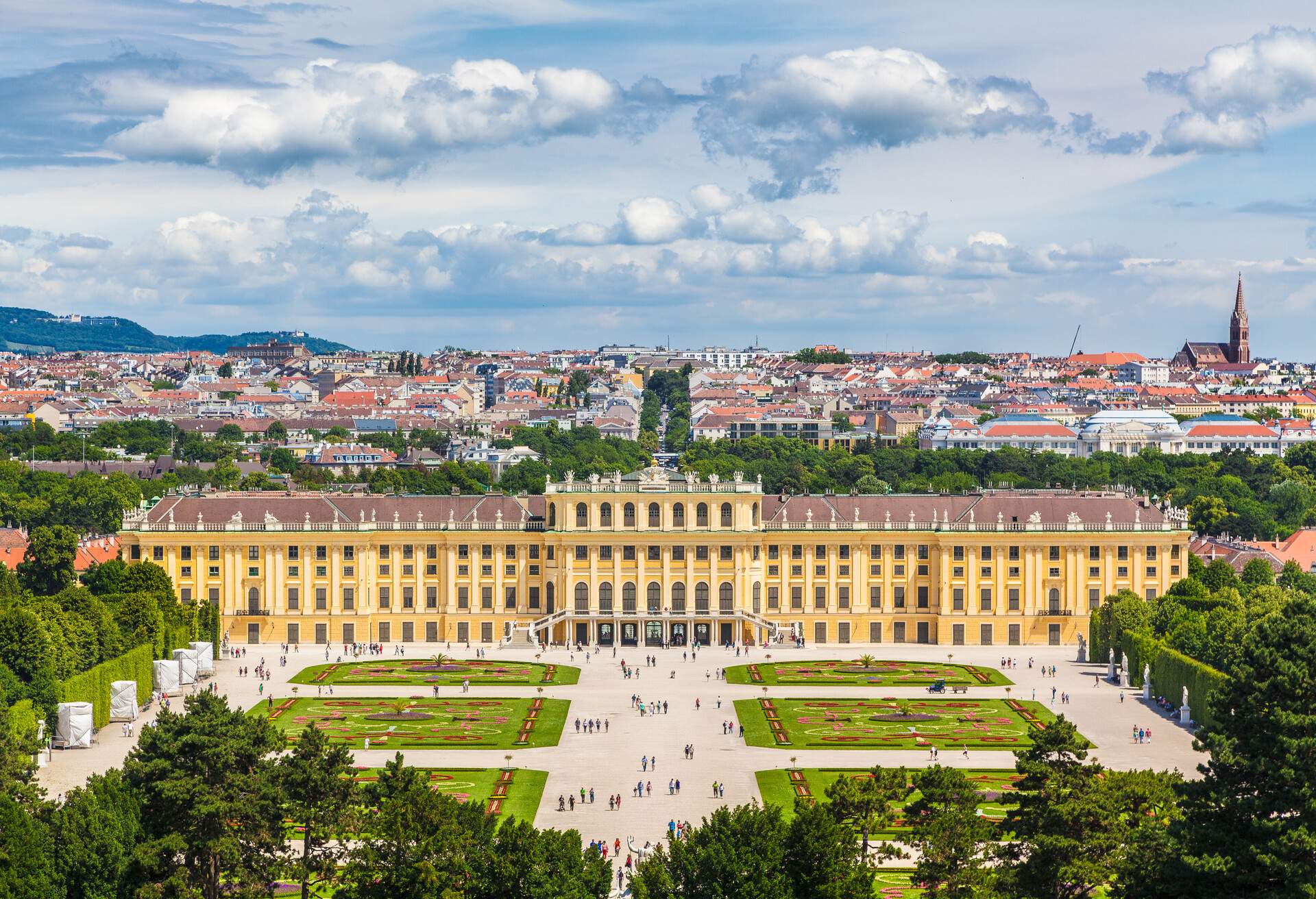 Classic view of famous Schonbrunn Palace with scenic Great Parterre garden on a beautiful sunny day with blue sky and clouds in summer, Vienna, Austria; Shutterstock ID 583714789