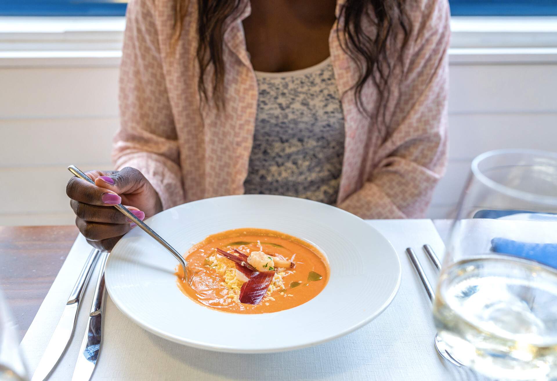 Close up view of a woman eating “salmorejo” in a restaurant. Typical Spanish food