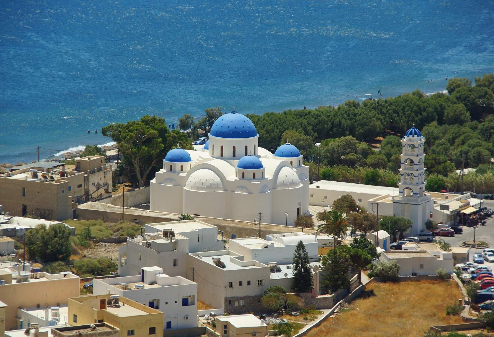 A sunny day and the church of Timiou Stavro, the Holy Cross in Perissa on Santorini; Shutterstock ID 737877001