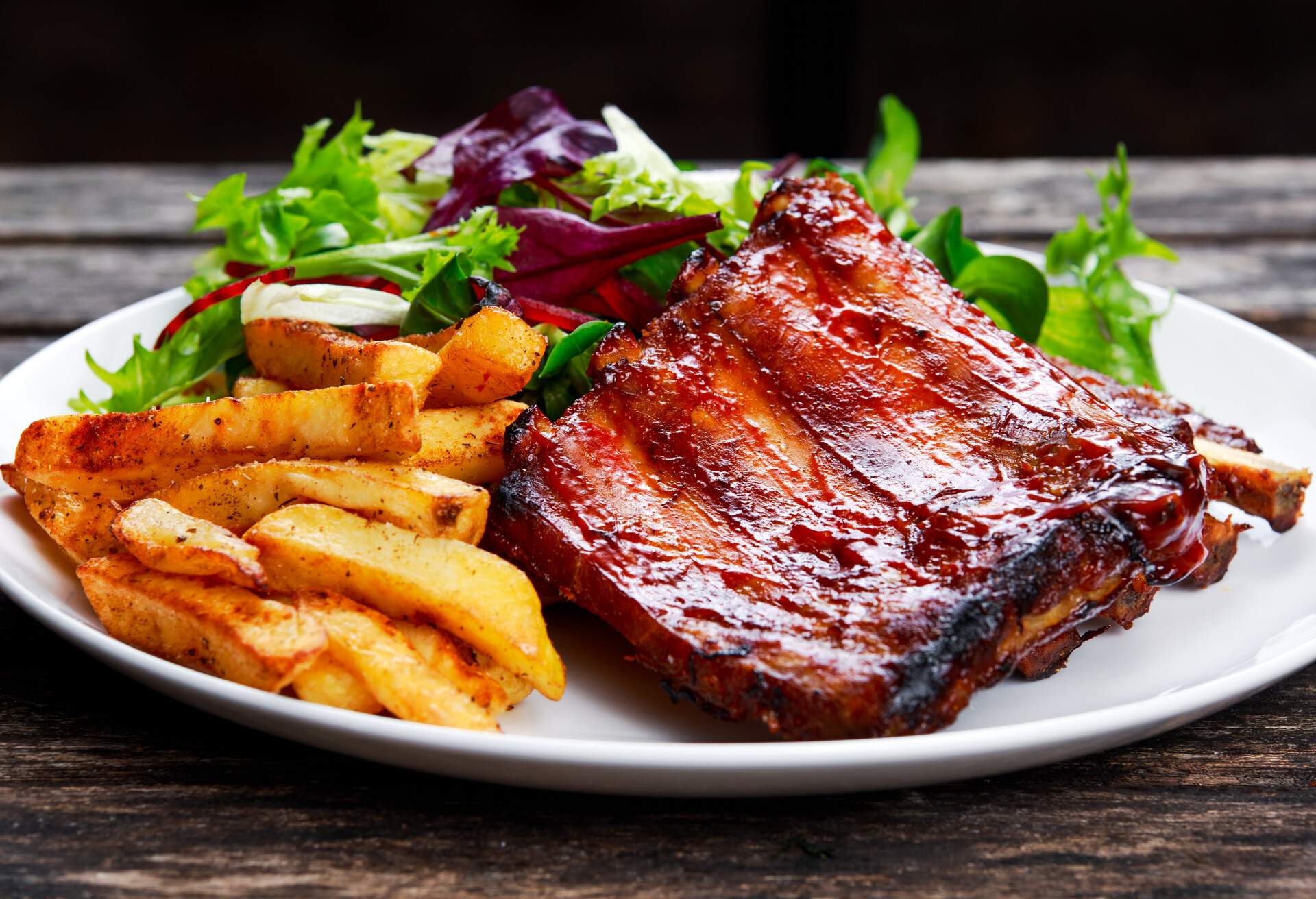 Roasted Pork Rib, Fried Potato on white plate with Vegetables