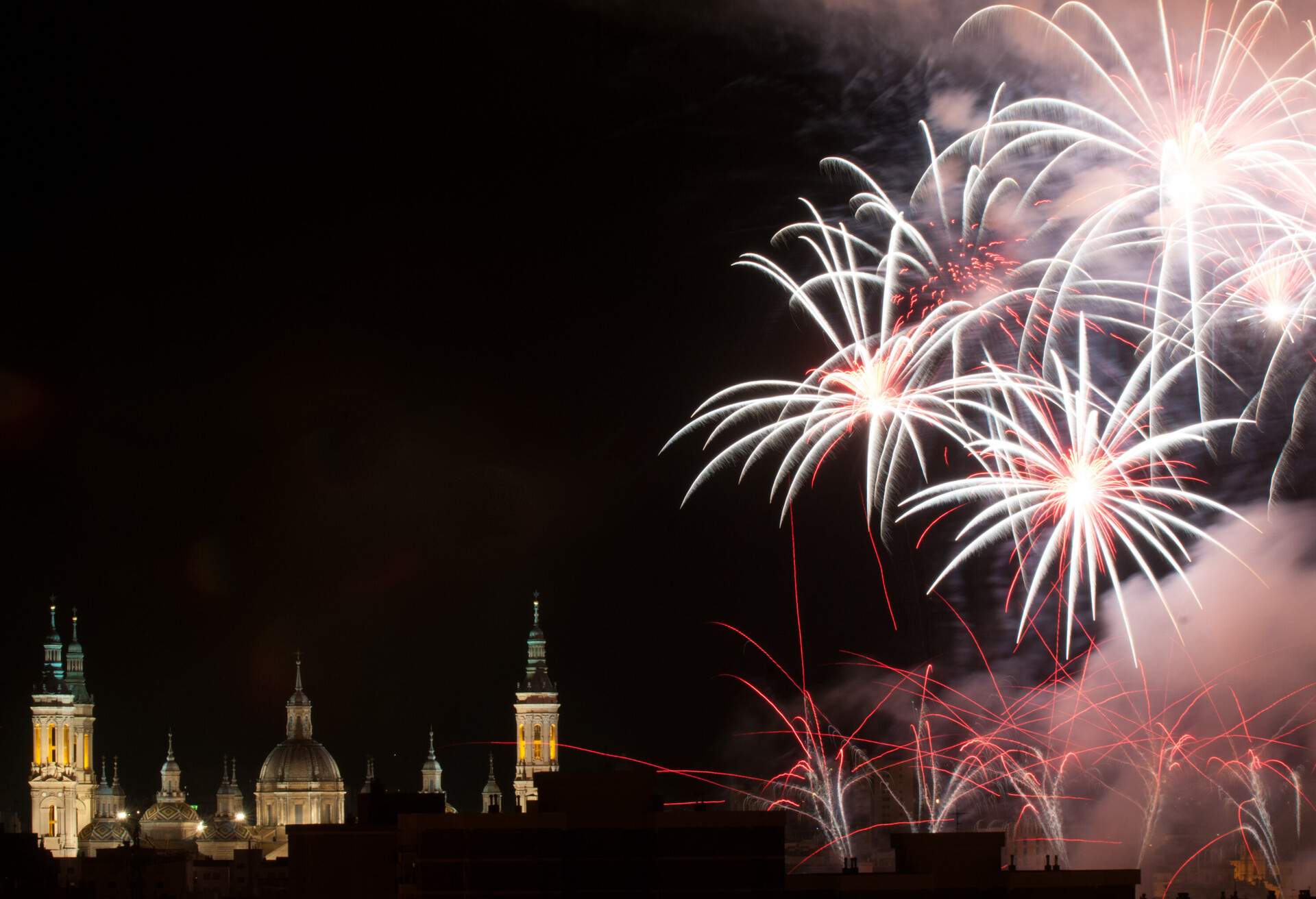 Fireworks on the sky near of the Pilar Basilica, in Zaragoza, Spain, during the local festivities