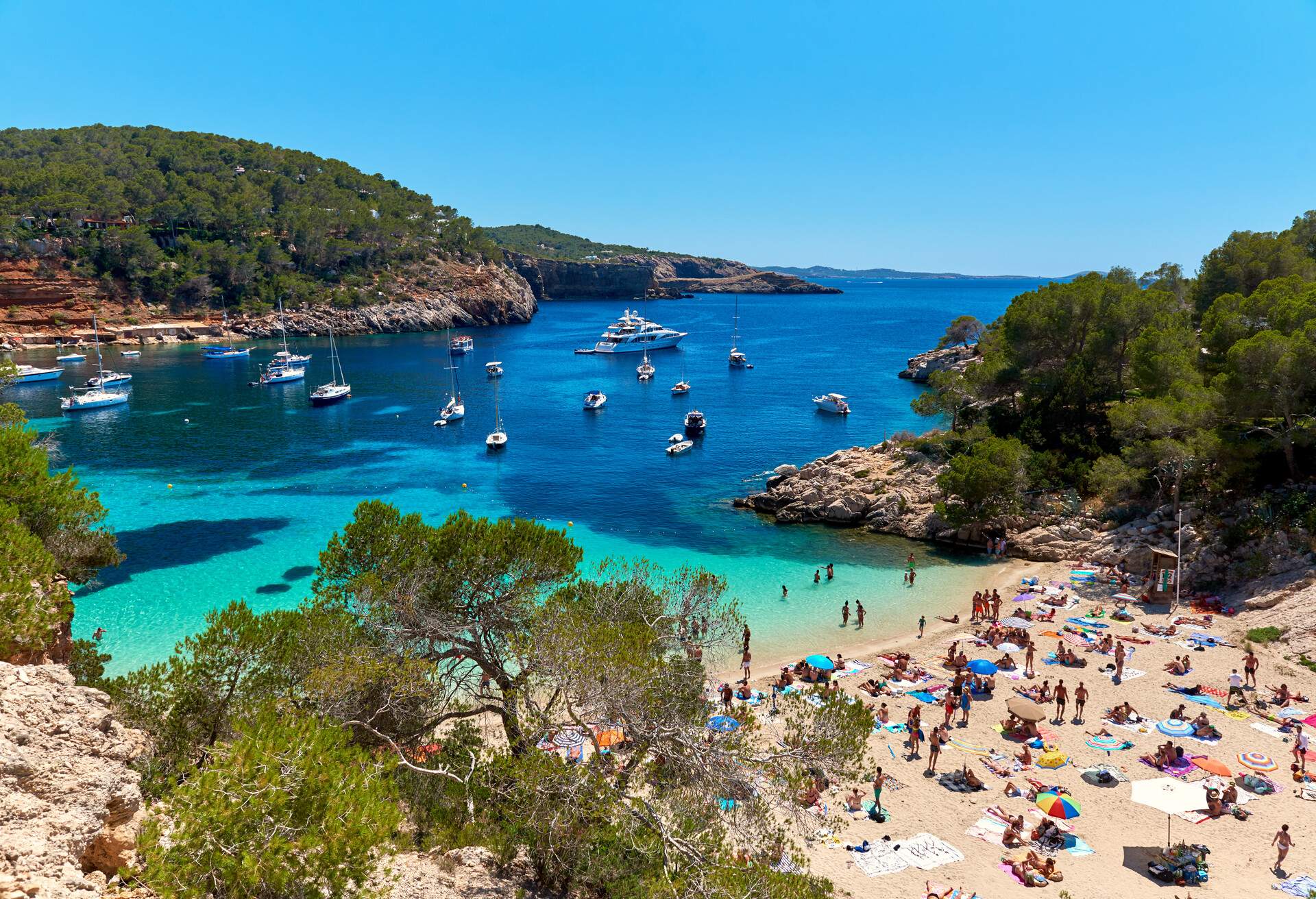 People enjoying vacations in the Cala Salada lagoon. Idyllic scenery. Ibiza, Balearic Islands. Spain