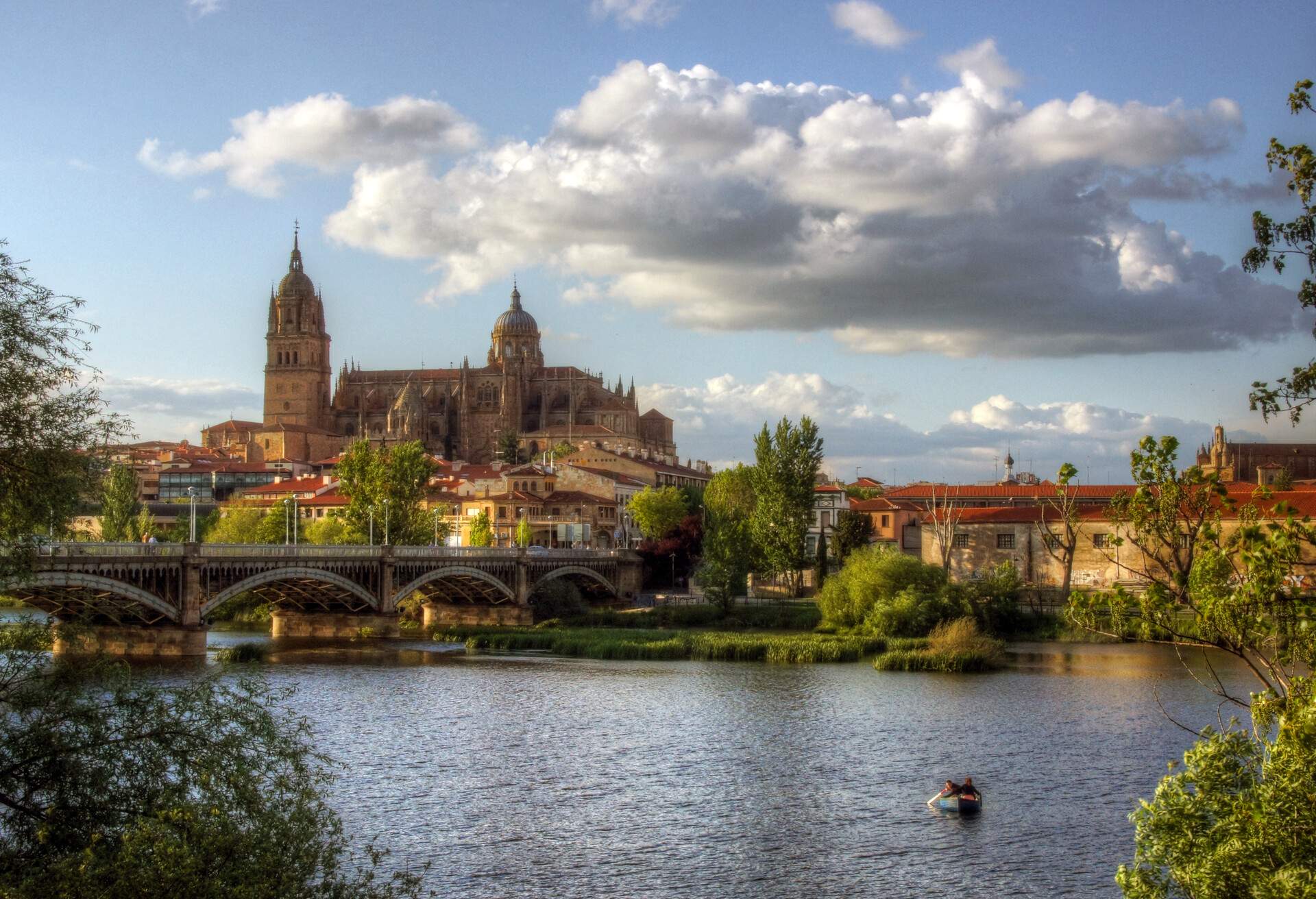Salamanca old town, Roman Bridge and small boat.