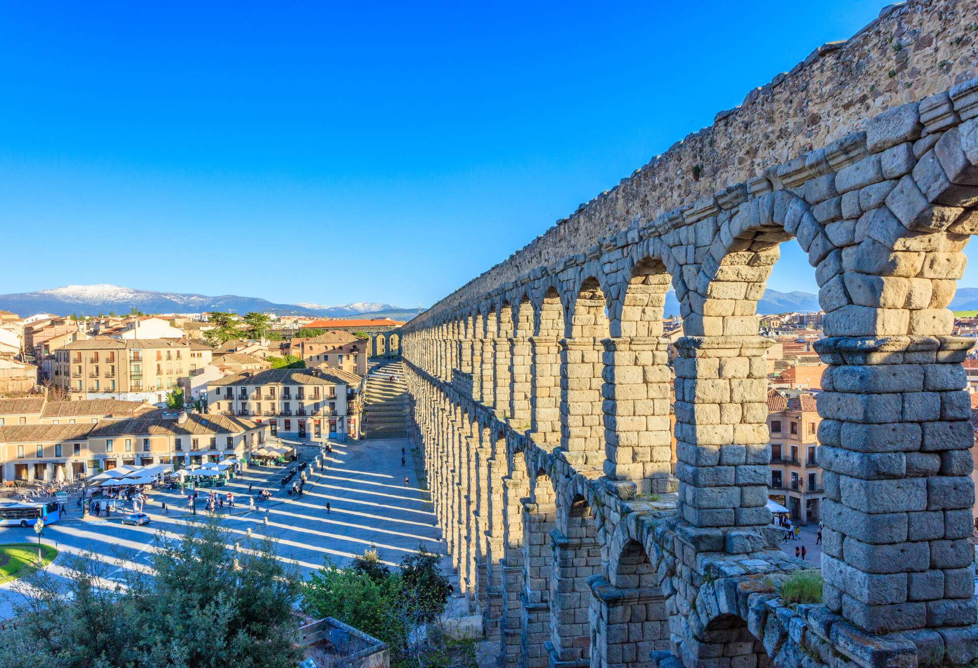 View of Roman Aqueduct at Plaza del Azoguejo in Segovia, an iconic symbol of the UNESCO listed city. The aqueduct was originally part of a complex system of aqueducts and underground canals that brought water from the mountains more than 15km away.