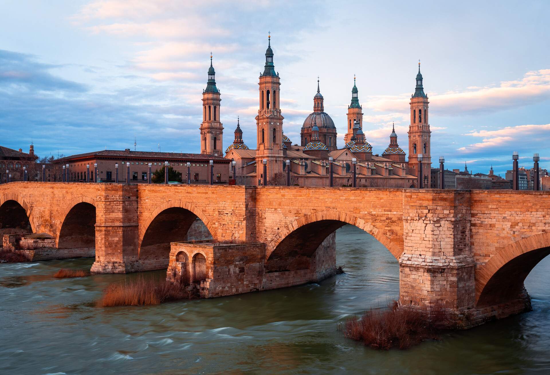 Sunset at Basilica de Nuestra Senora del Pilar, Basilica of Our Lady of the Pillar, Puente de Piedra (bridge), Zaragoza, Aragon, Spain