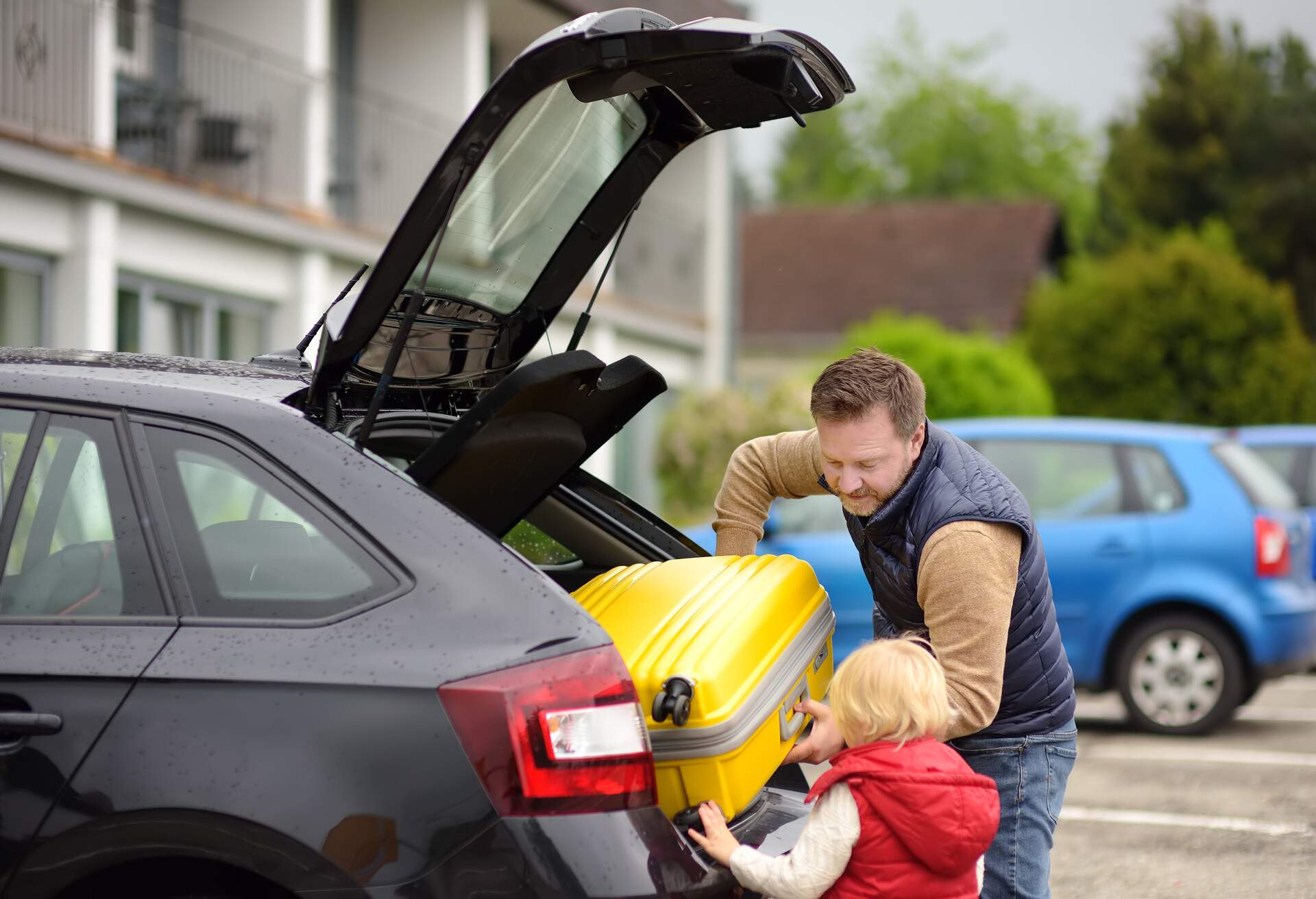 Handsome man and his little son going to vacations, loading their suitcase in car trunk. Automobile trip in the countryside. Roadtrip for family with little kids; Shutterstock ID 1437552449