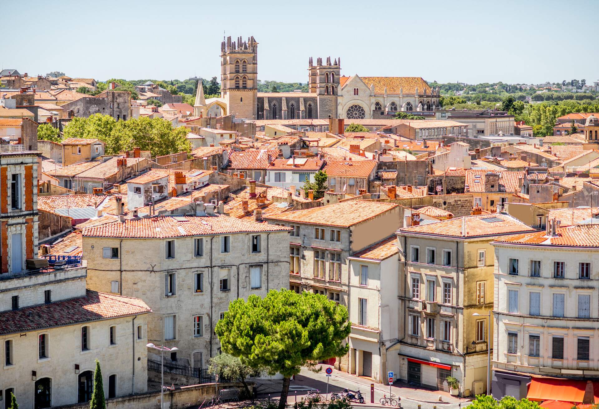 Aerial cityscape view on the old town with cathedral in Montpellier city during the sunny weather in Occitanie region of France