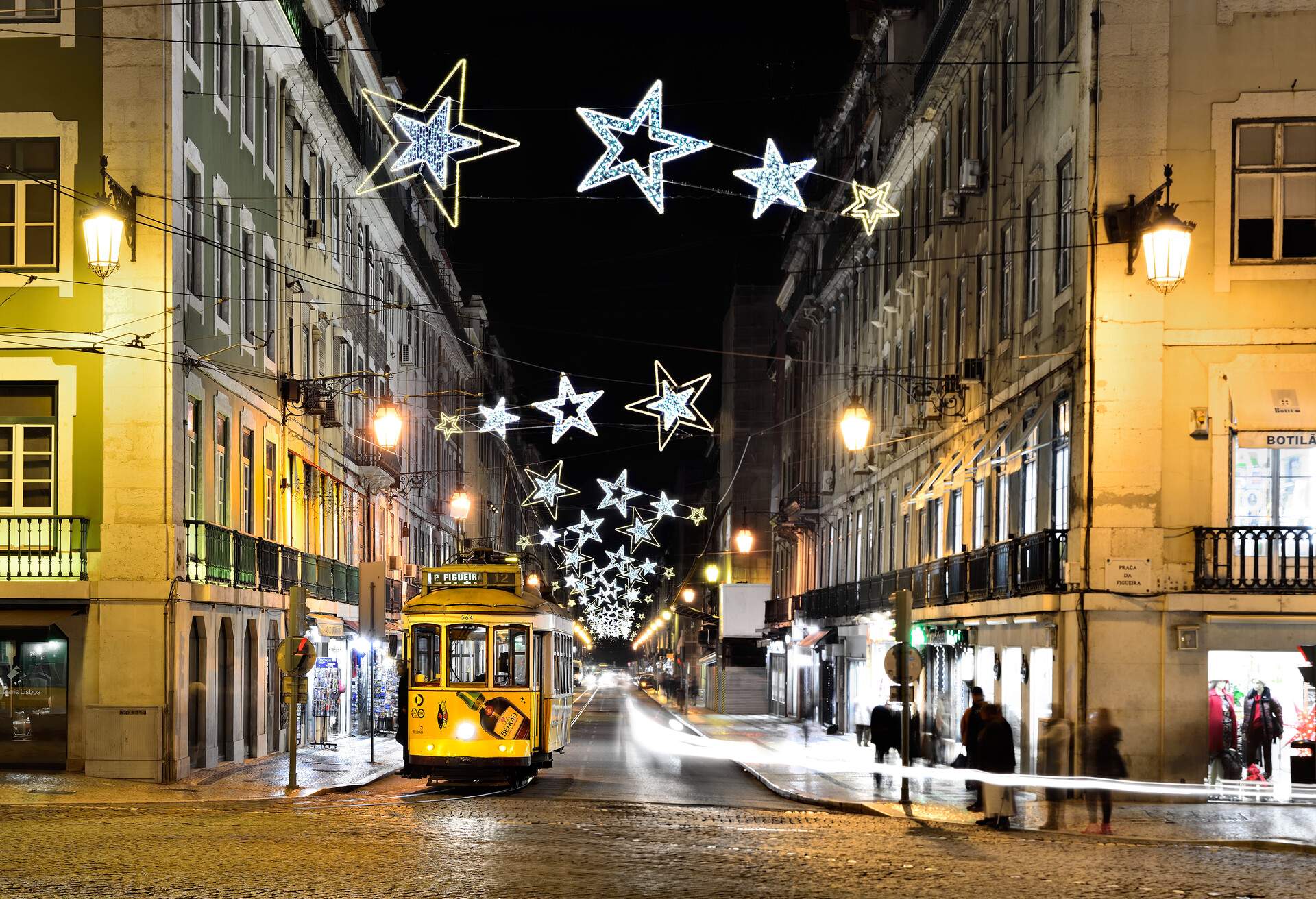 Christmas at Lisbon downtown, a old tram, and christmas street light decoration.