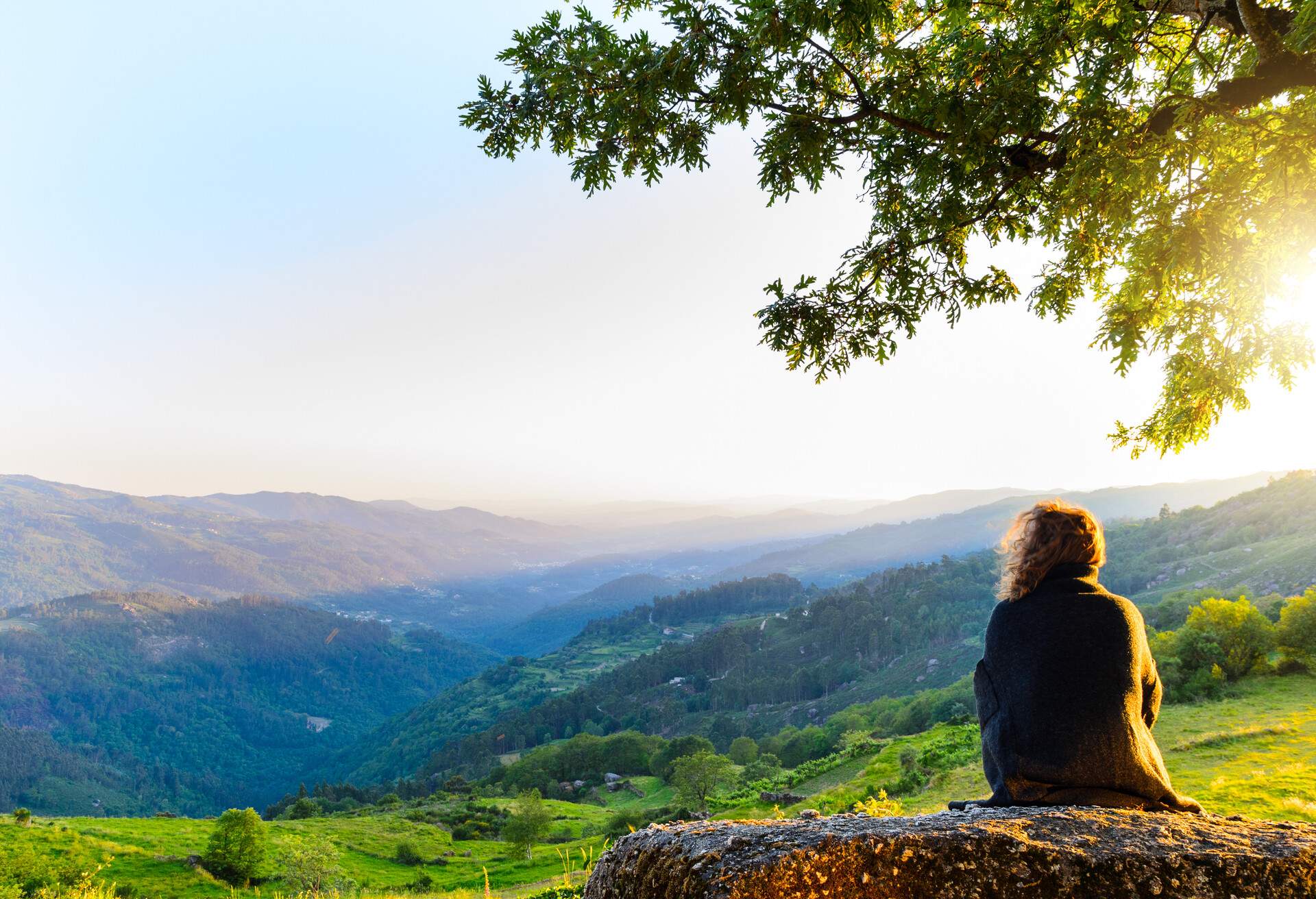 scenic view of woman watching at sunset mountains, Peneda-Geres National Park, northern Portugal.