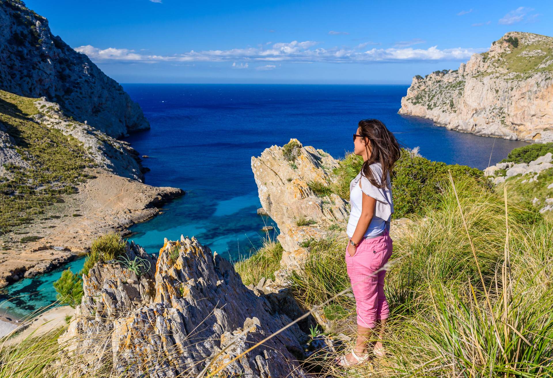 Girl at cala figuera at cap formentor - beautiful coast and beach of Mallorca, Spain