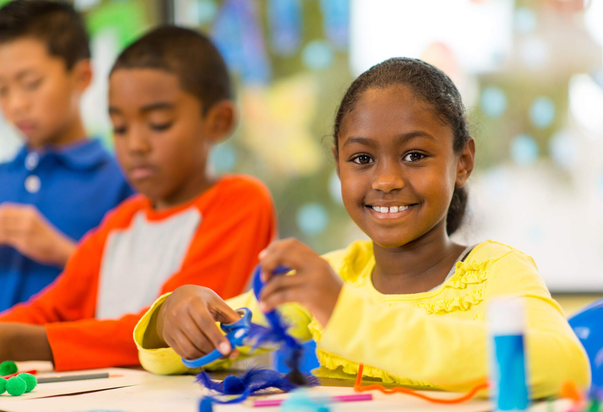 Elementary age children at the art center working on a creative project.