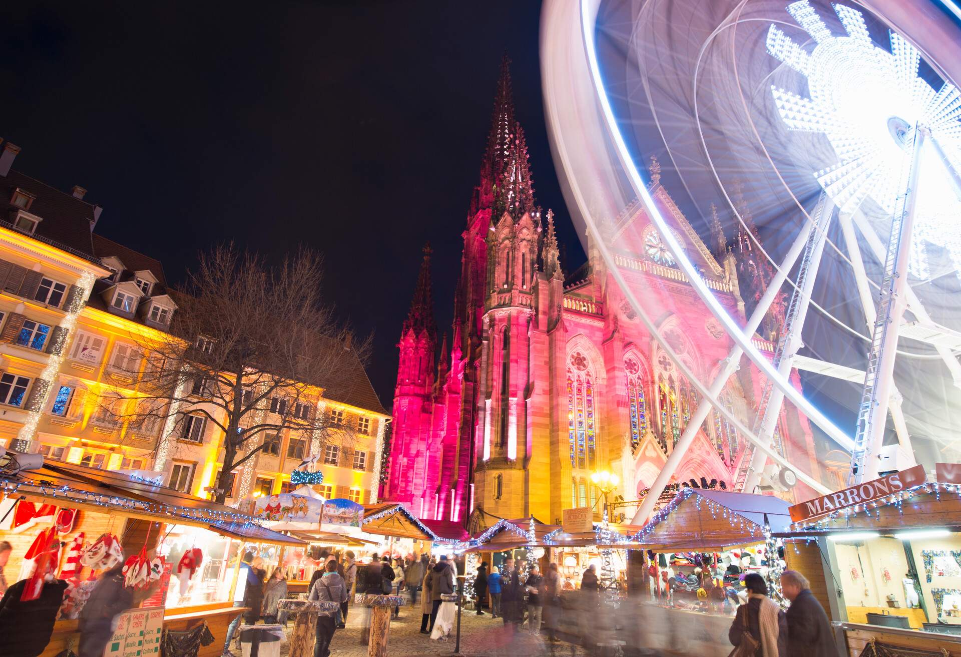 ferris wheel and cathedral and Christmas market in Mulhouse at night France
