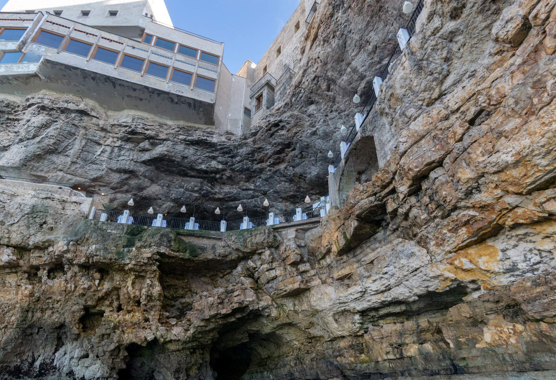 POLIGNANO, ITALY - 16 AUg 2016: The seafront entrance of Grotta Palazzese, a natural sea cave now part of a high end restaurant, in Polignano a Mare, Apulia, Italy