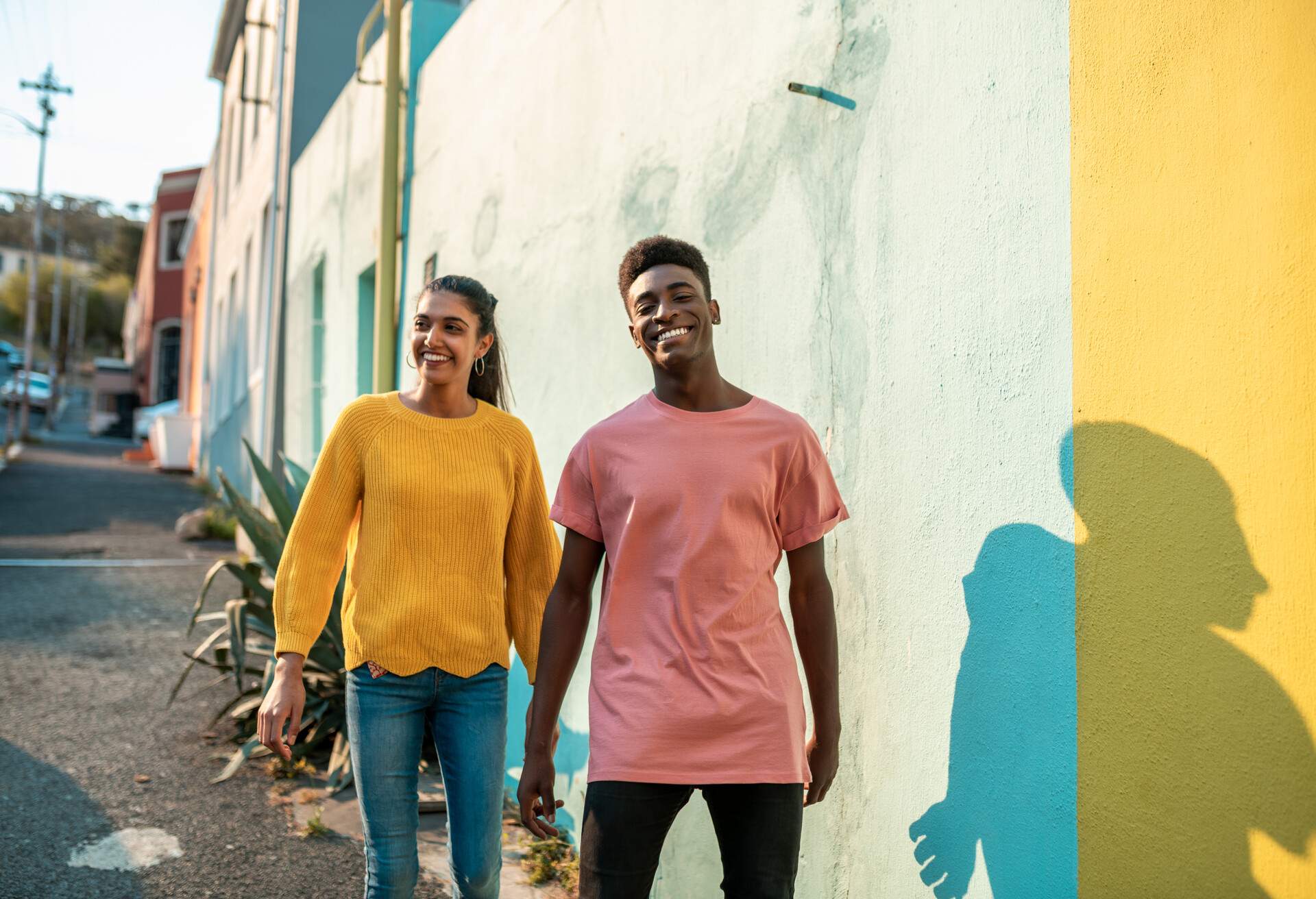 Young happy couple visiting Bo Kaap area in Cape Town.