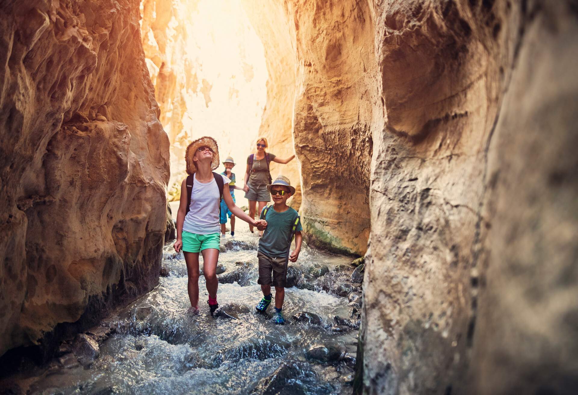 Mother and kids hiking through river Rio Chillar in Andalusia, Spain. 