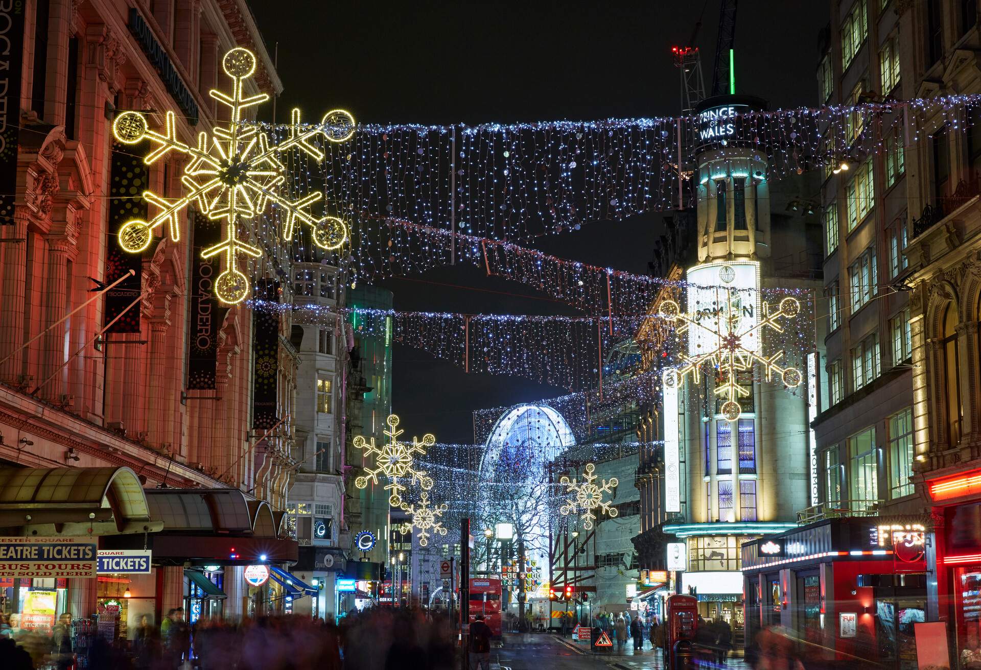 Christmas lights along Coventry street looking toward Leicester Square illuminated at night