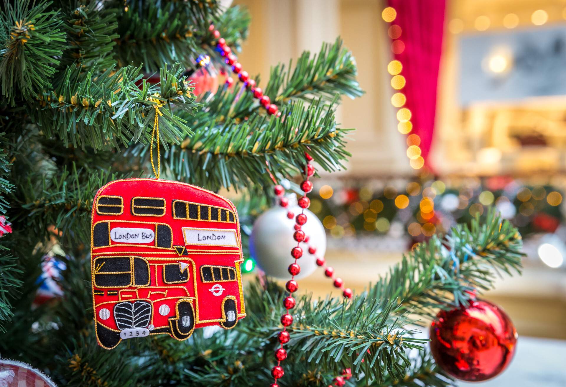 Christmas tree decoration with british red bus; Shutterstock ID 237170890; Purpose: Blogs; Brand (KAYAK, Momondo, Any): Any