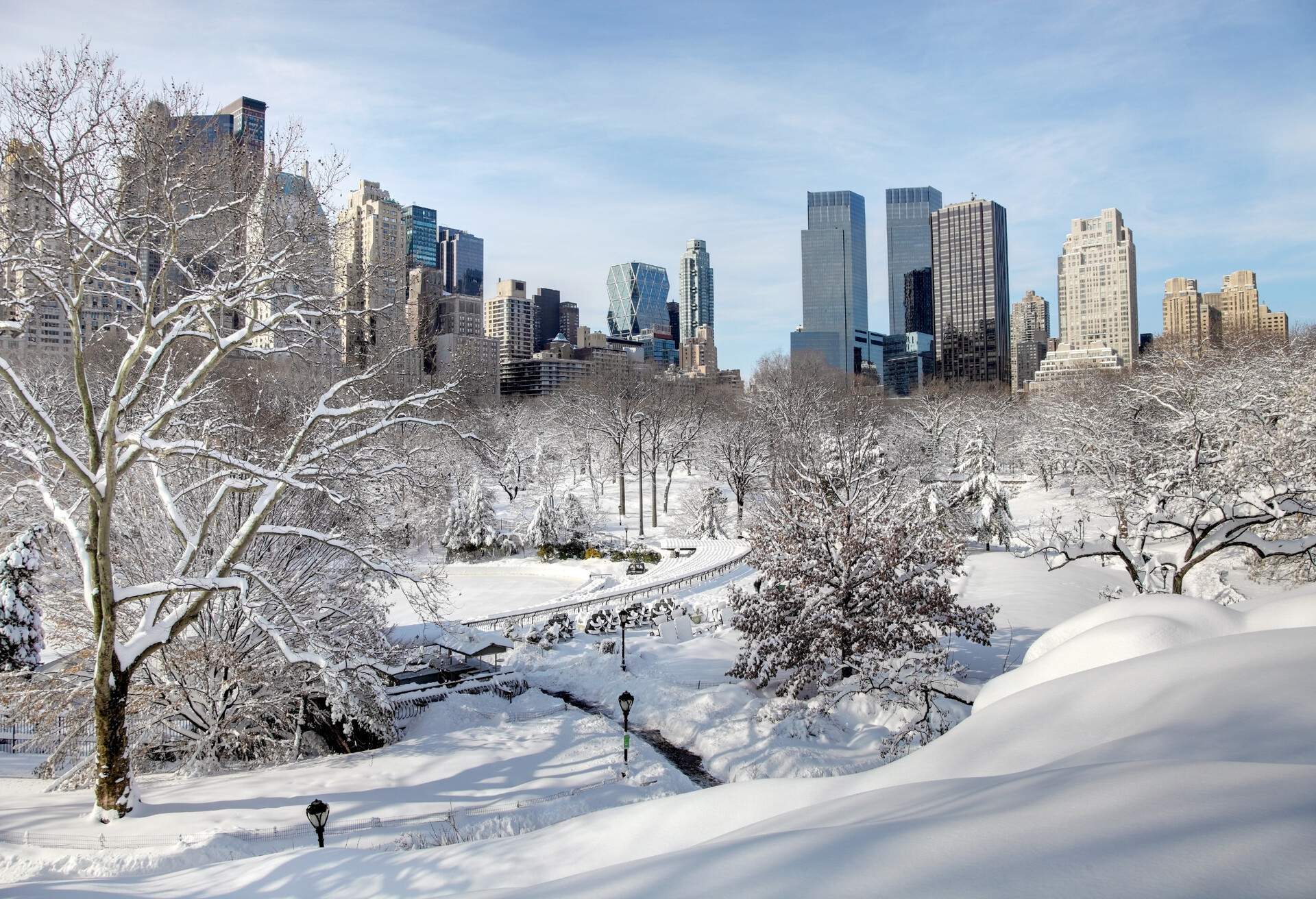 blizzard in New York City turns Central Park into a winter wonderland. Photo taken from a scenic viewpoint showing the Manhatten skyline rising from the snow covered  trees.