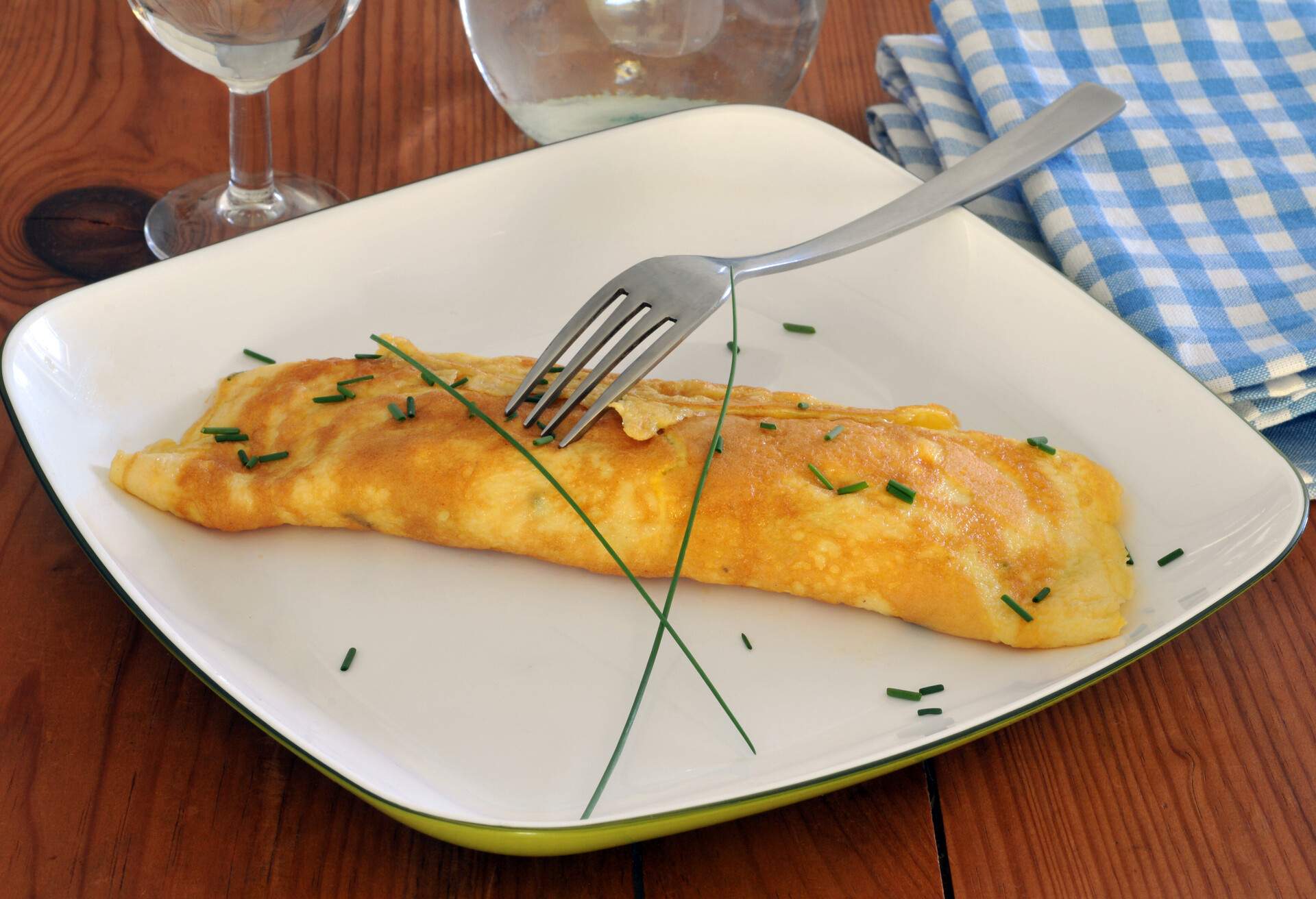 omelette rolled on a plate with chives