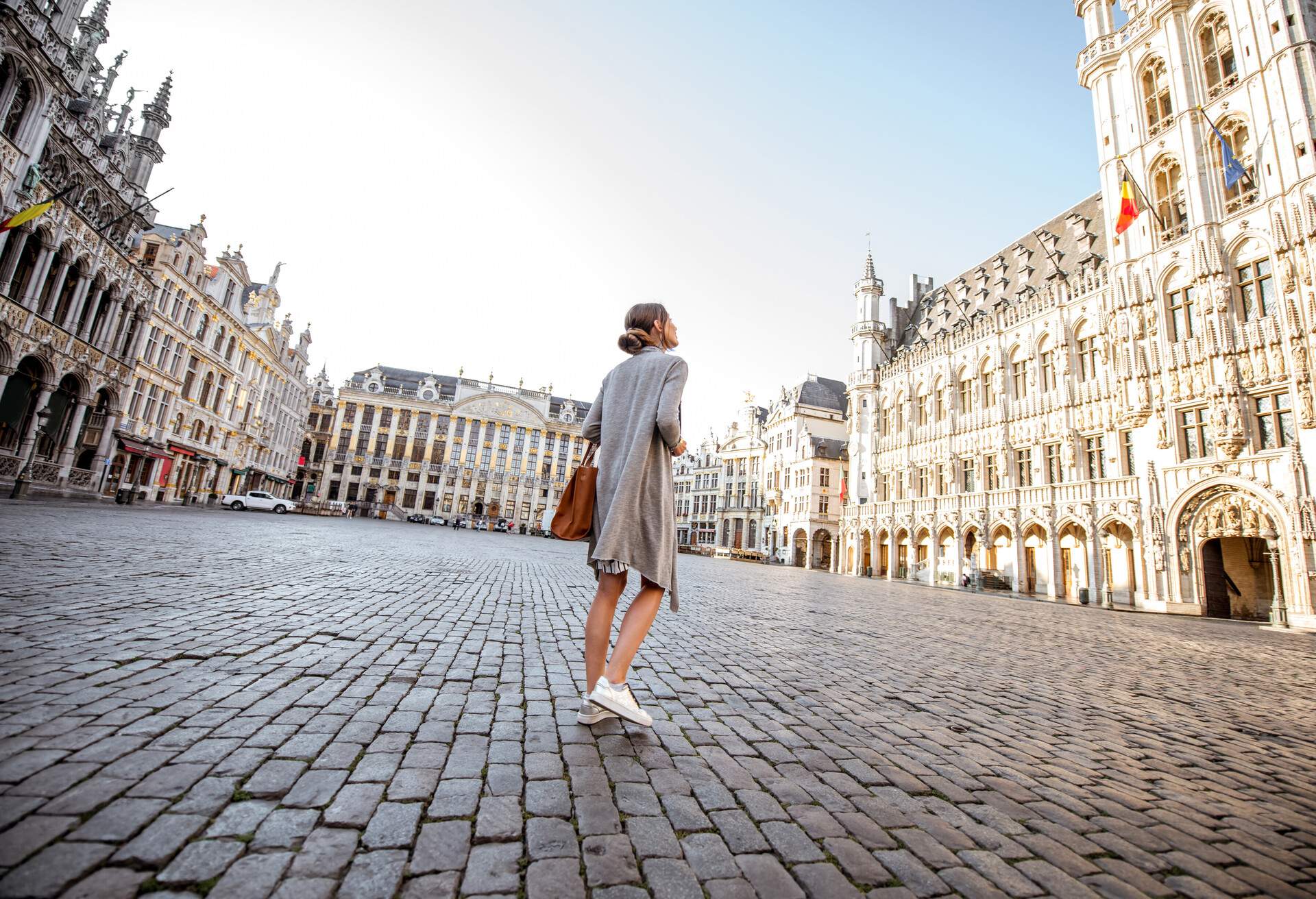 Young female tourist walking on the main square with city hall in the old town of Brussels in Belgium