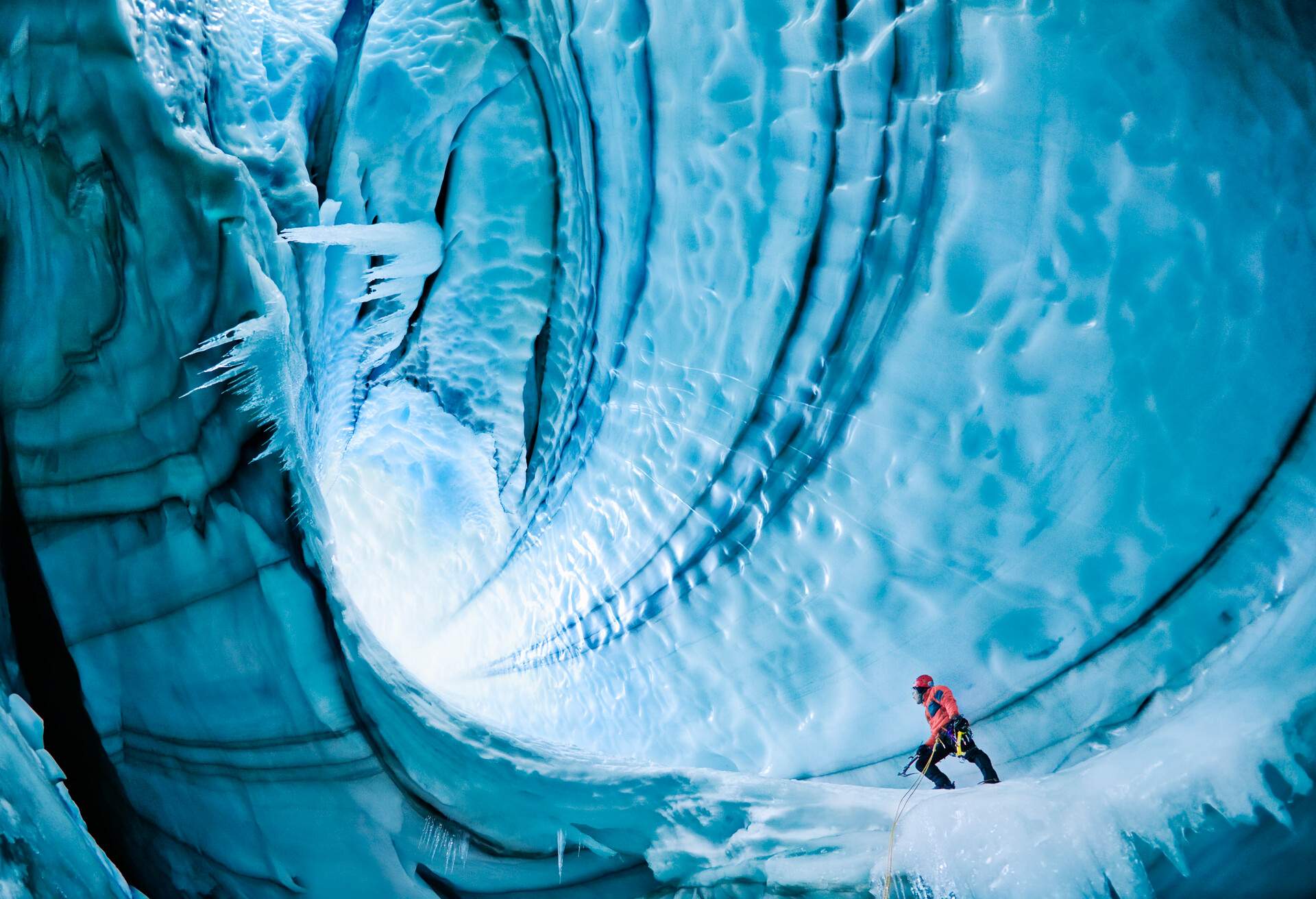 Langjokull Glacier, Iceland. Caves are formed from either hot springs underneath glacier or meltwater from surface. Climber is 80 feet below surface of glacier 