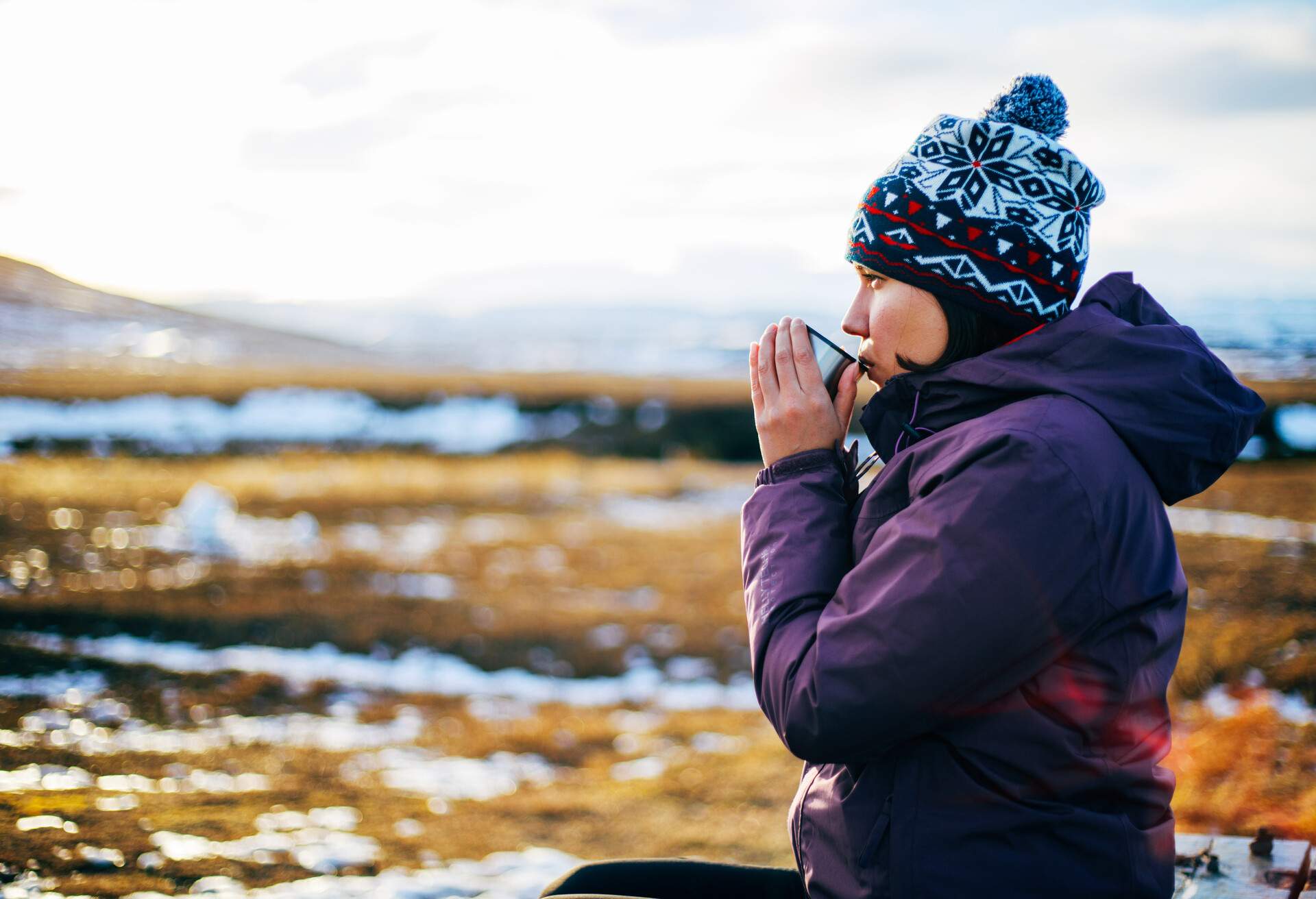 Woman drinks hot tea or coffee