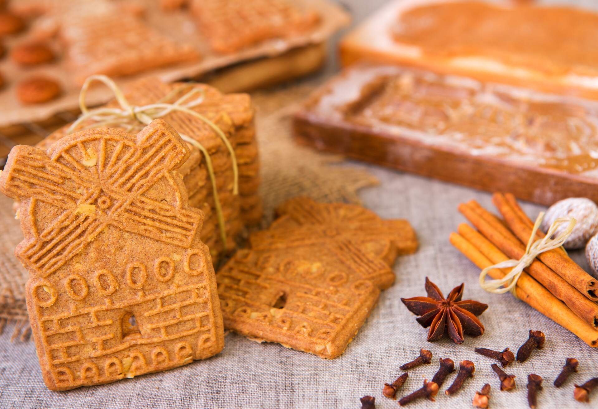 Traditional Dutch 'speculaas' (spiced shortcrust cookies). With authentic wooden cookie cutters especially made for these cookies in the background.