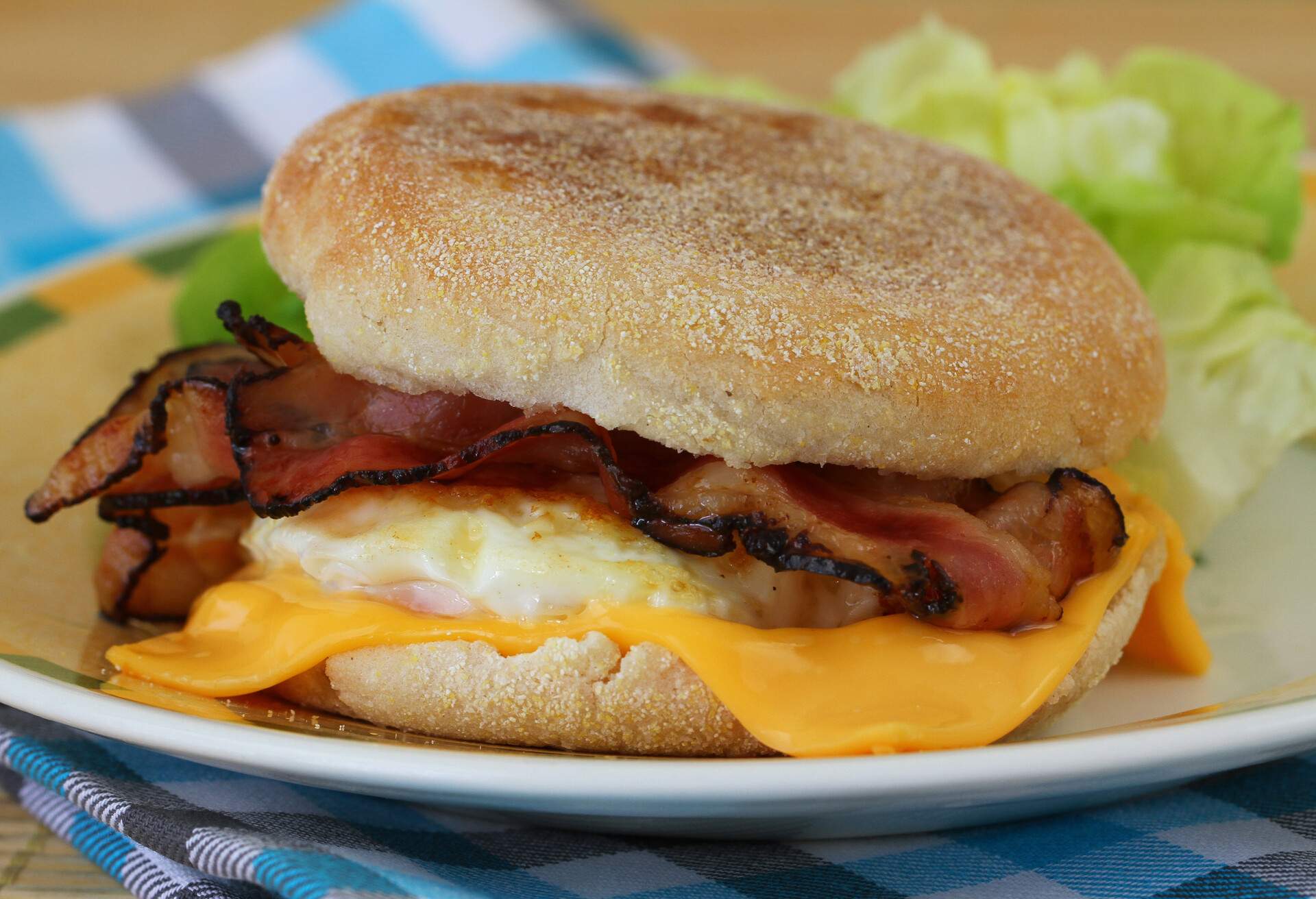 English muffin with fried egg, bacon and cheese