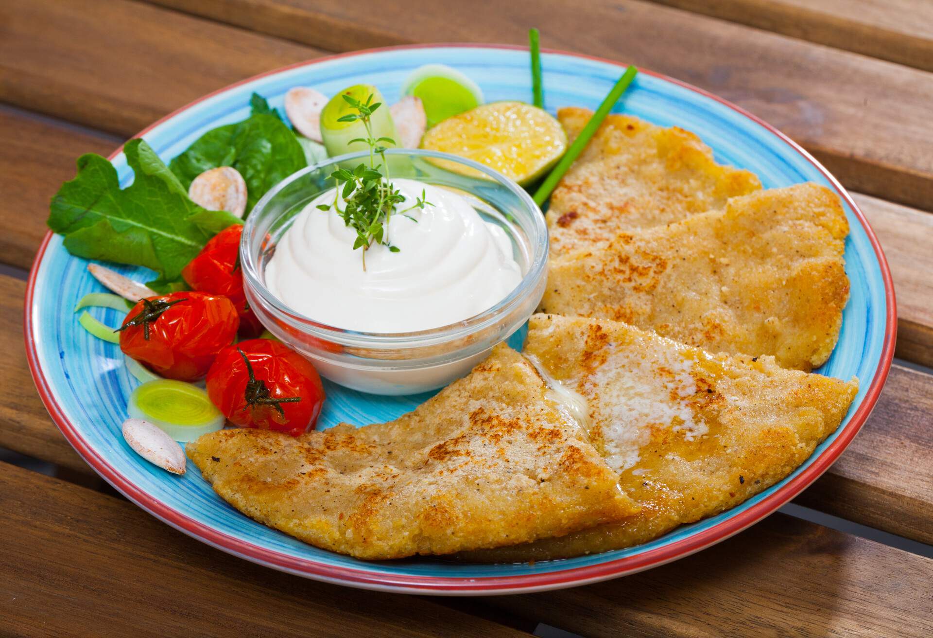 Potato scones served with vegetables and greens on plate â€“ Scottish cuisine