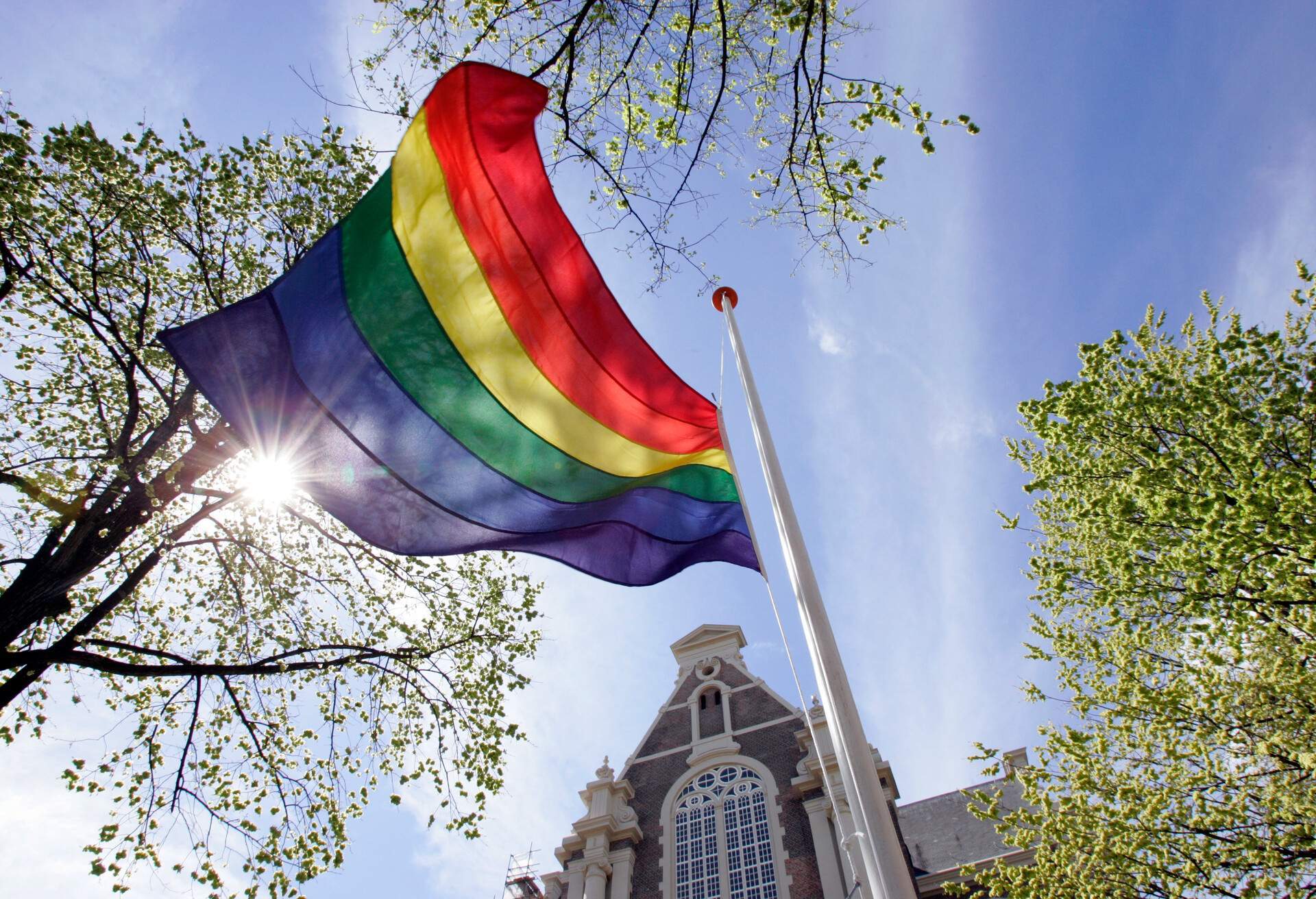 Rainbow flag flies in the mast at Homomonument in front of the Wester Church in Amsterdam,Netherlands.