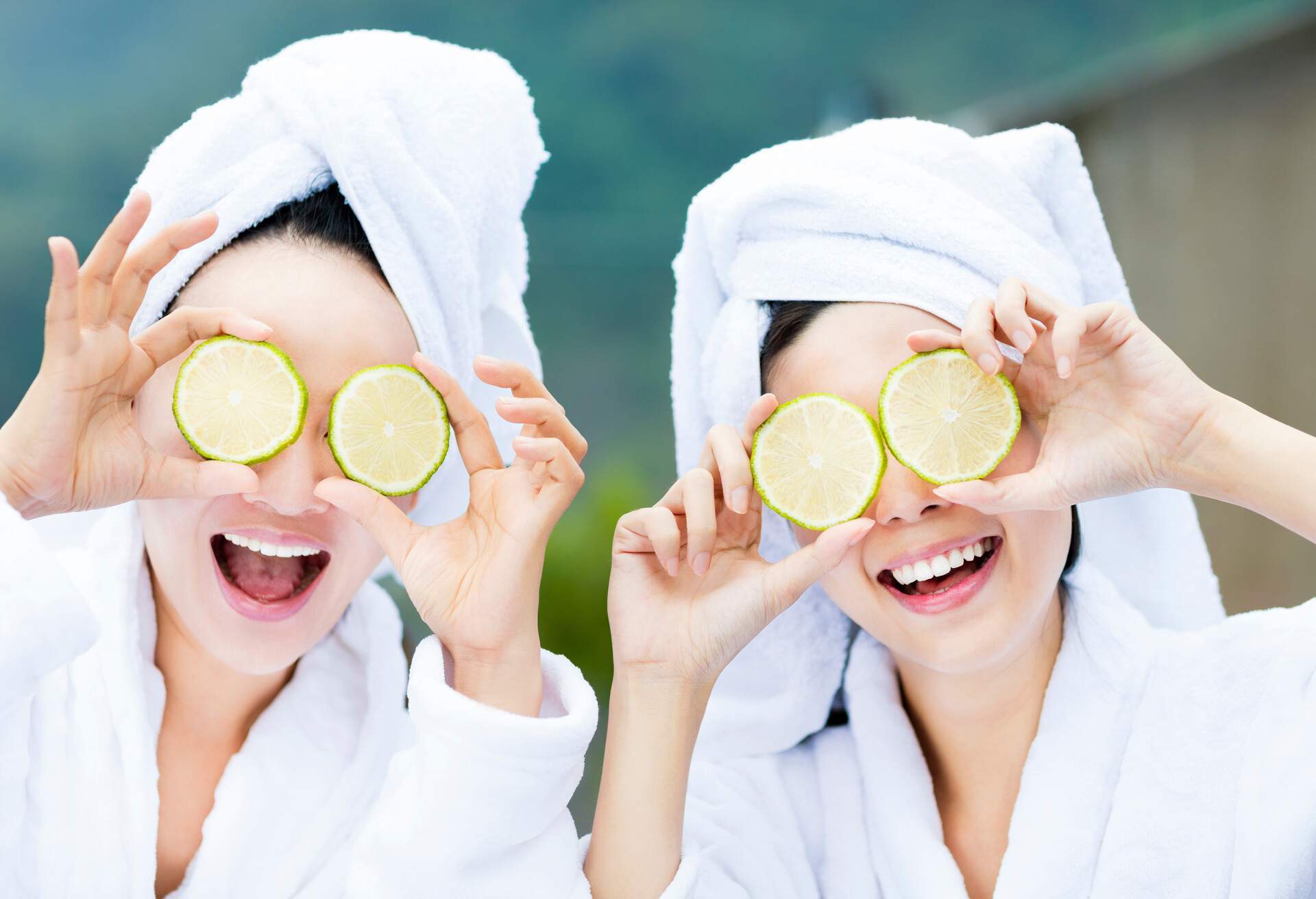 beautiful woman showing fresh lemon in spa 