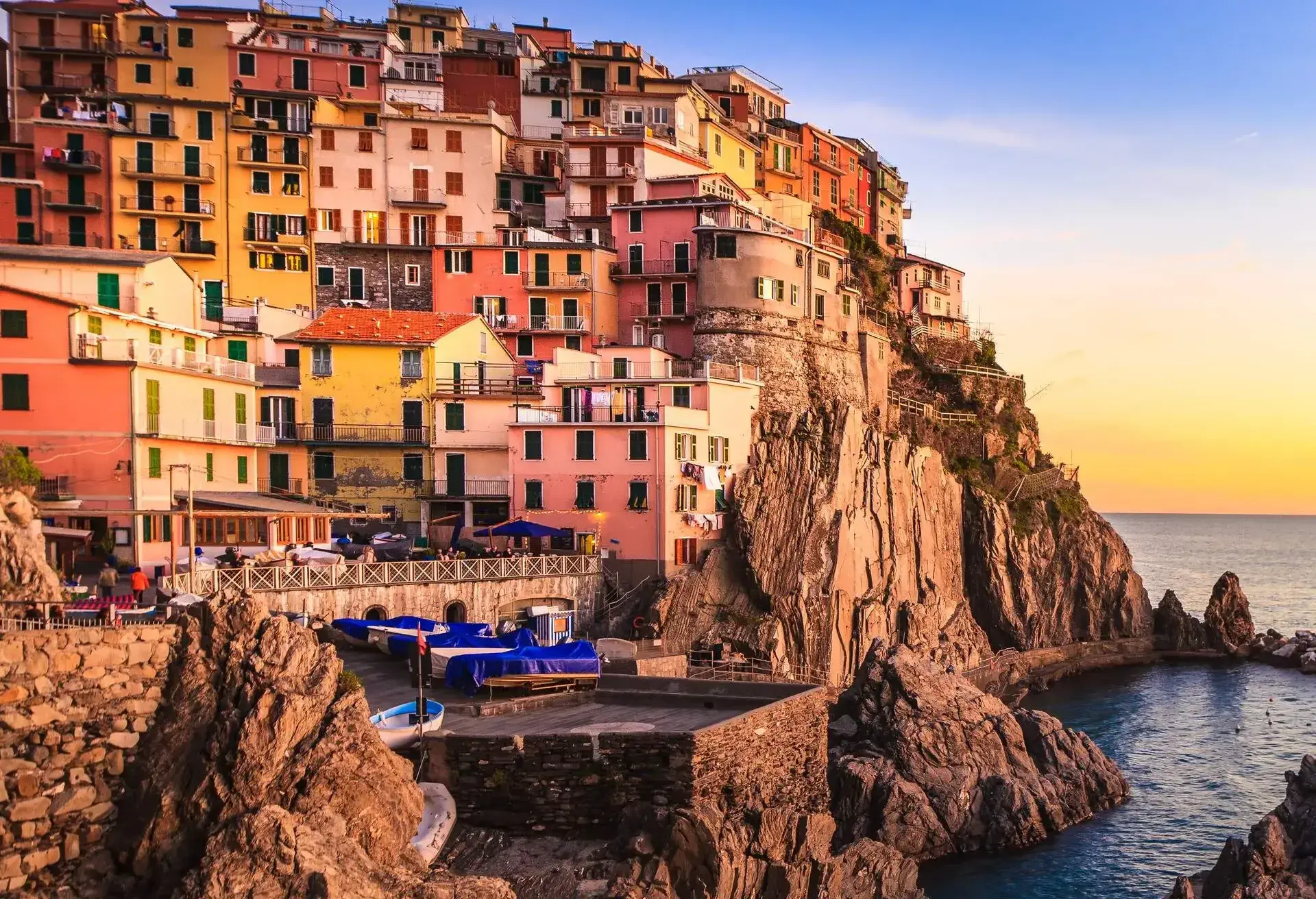 Manarola village on cliff rocks and sea at sunset., Seascape in Five lands, Cinque Terre National Park, Liguria Italy Europe. Long Exposure Photography.; Shutterstock ID 149734841; Purpose: destinations; Brand (KAYAK, Momondo, Any): any