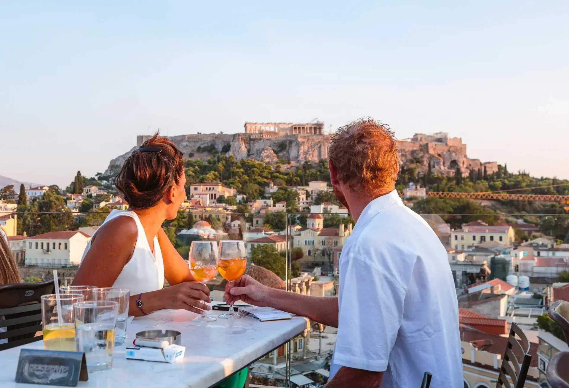 DEST_GREECE_ATHENS_ACROPOLIS_PEOPLE_COUPLE_MAN_WOMAN_DINNER_DRINKS_RESTAURANT_GettyImages-663376932-1.jpg