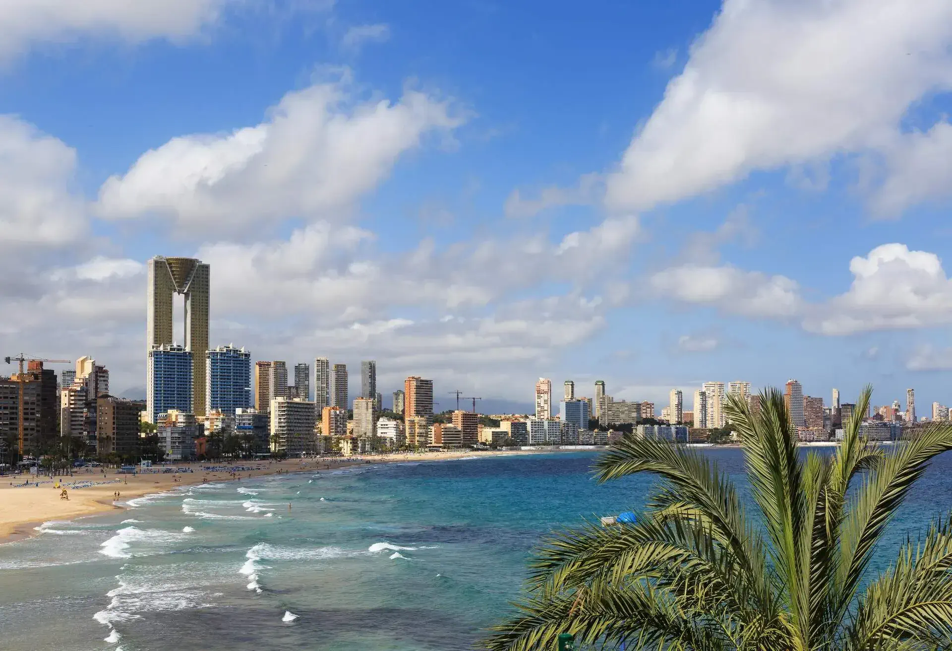 Benidorm is a town on the Costa Blanca in Spain, northeast of Alicante in the province of Alicante in the Valencian Community, Spain. Once a small village for fishing, today it is for mass tourism with many tall hotels and appartment buildings.