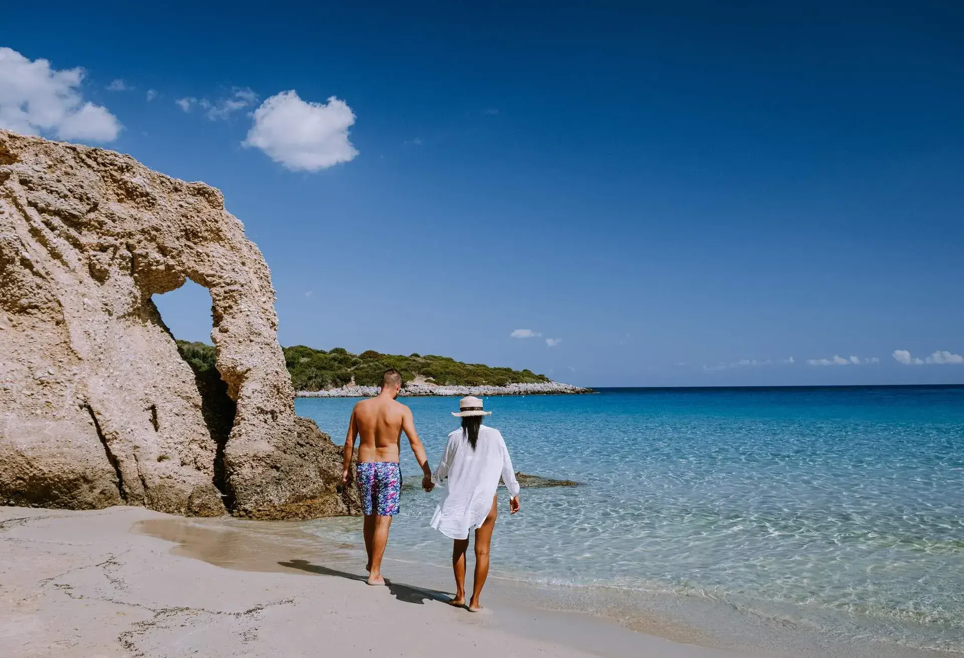 Tropical beach of Voulisma beach, Istron, Crete, Greece ,Most beautiful beaches of Crete island -Istron bay near Agios Nikolaos young couple mid age on vacation in Greece Crete
