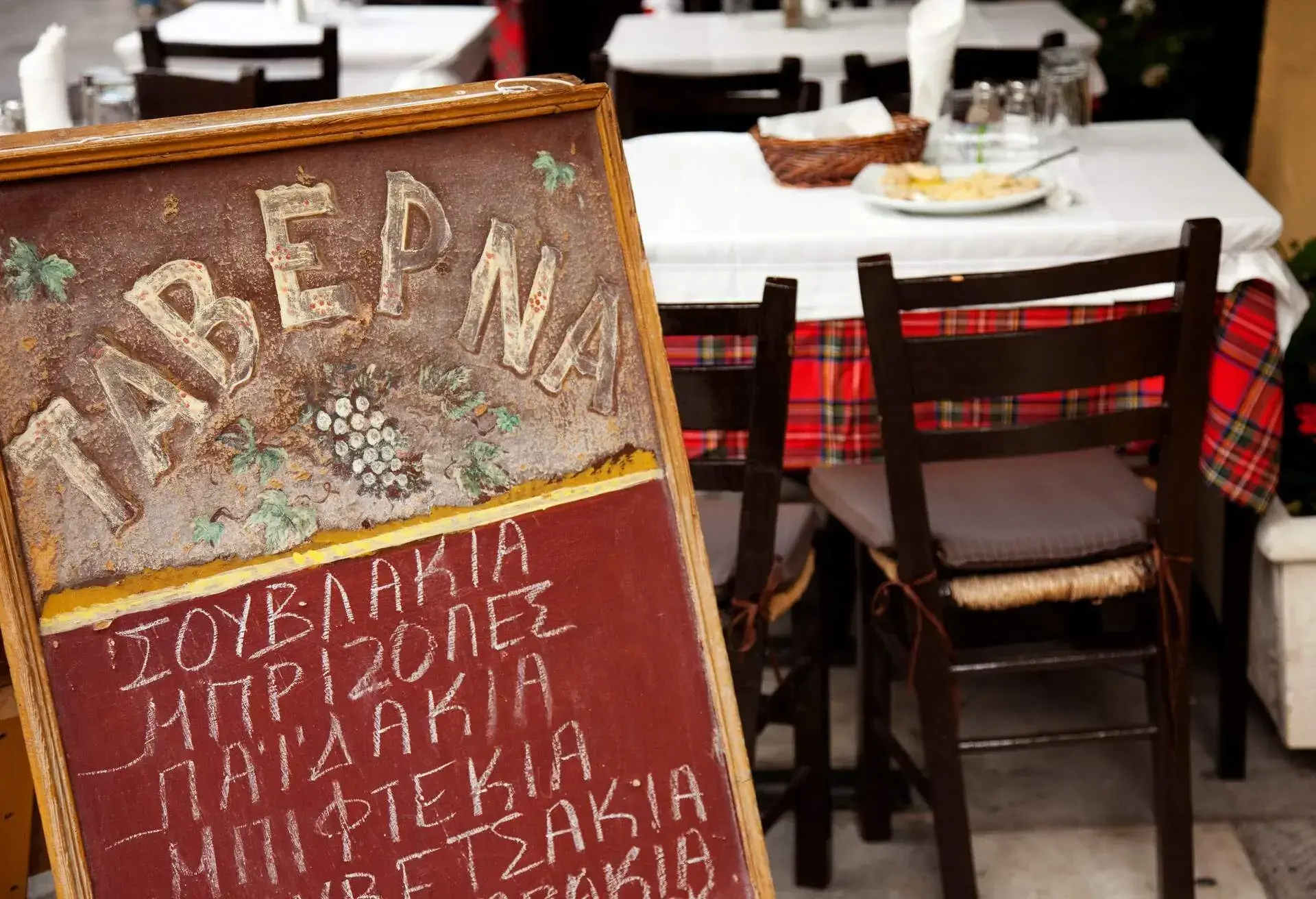 Typical greek tavern in the street in Plaka district, Athens, Greece