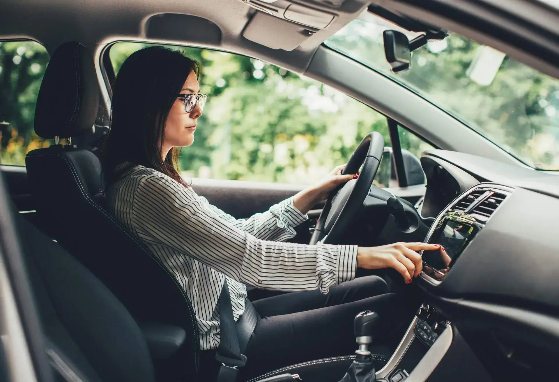 Woman using touchscreen navigation in her car