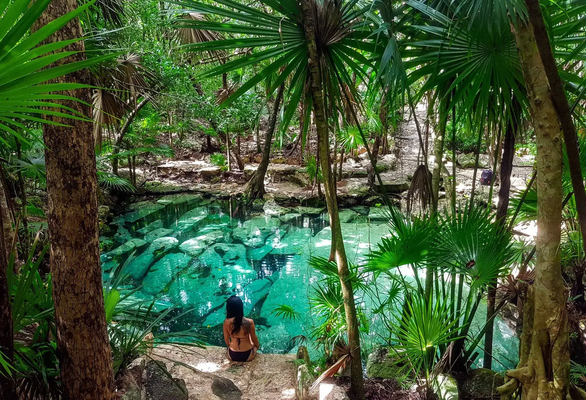 DEST_MEXICO_YUCATAN-PENINSULA_RIVIERA-MAYA_CENOTE-AZUL_PERSON_WOMAN_GettyImages-1168756348