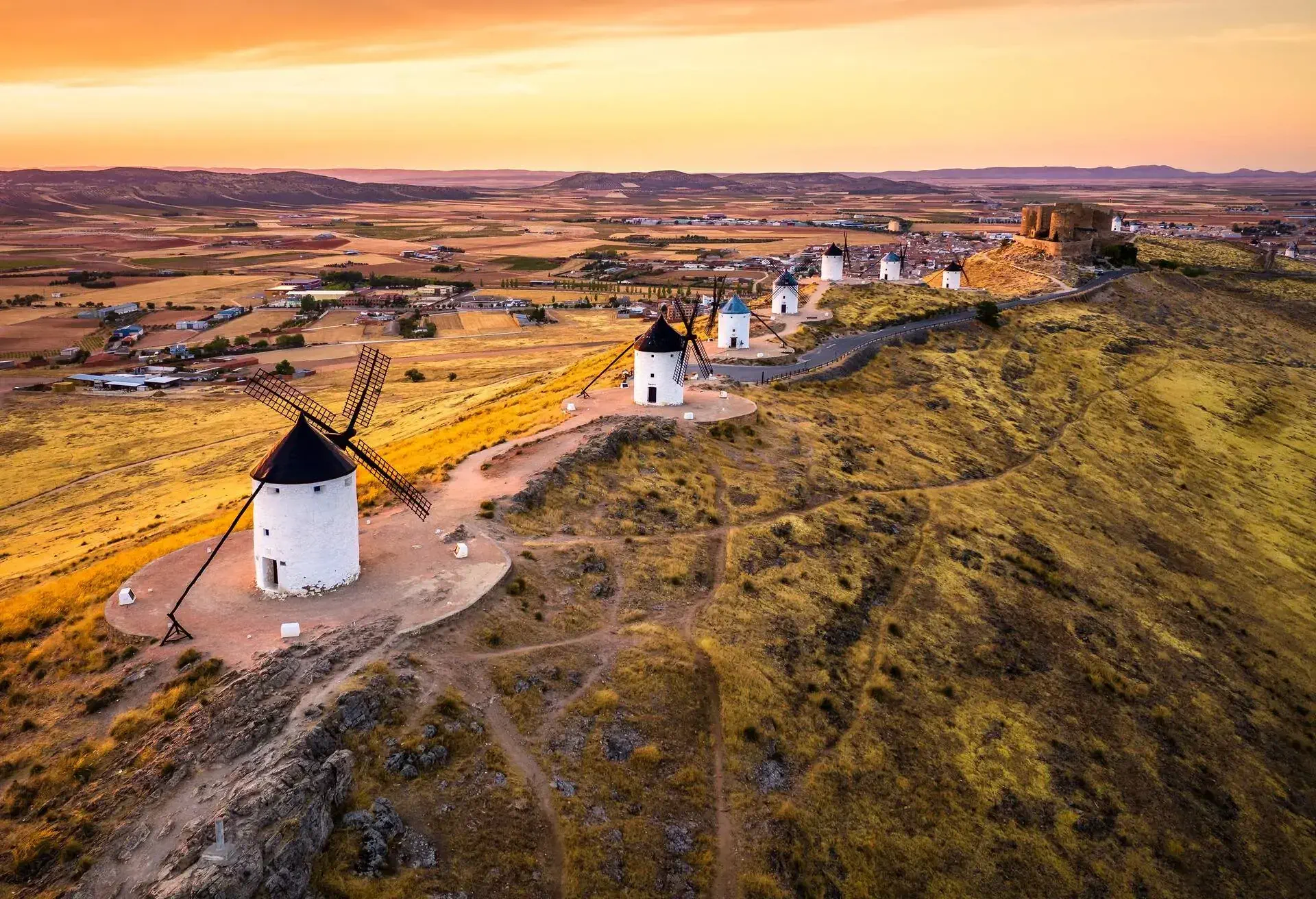 aerial view of traditional medieval spanish windmills in Consuegra at sunset. Castilla La Mancha, Spain