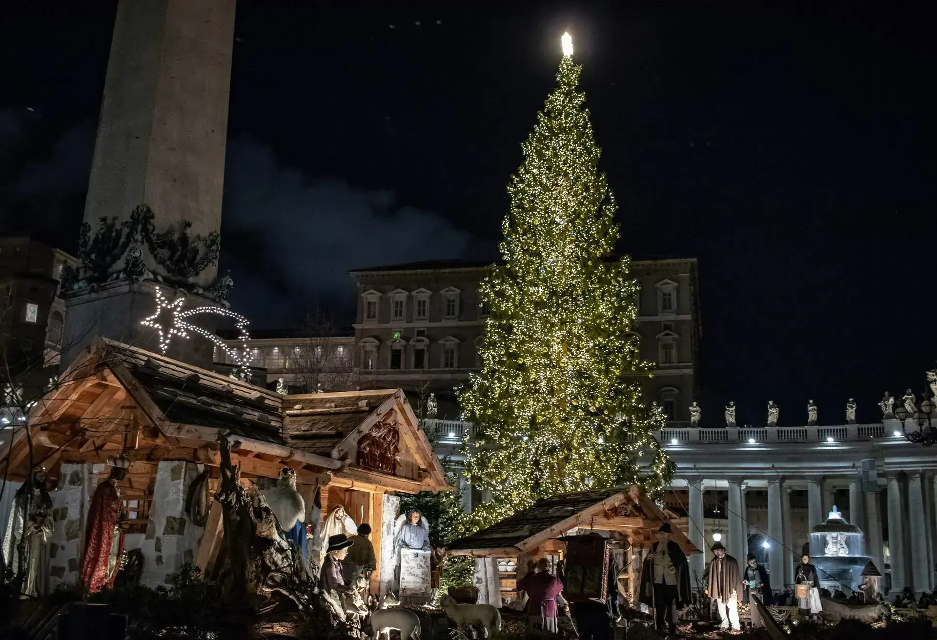 Rome Italy; 8 December 2019. In Piazza San Pietro the nativity scene reproduced with the wood of Trentino. With the Christmas tree in the background.