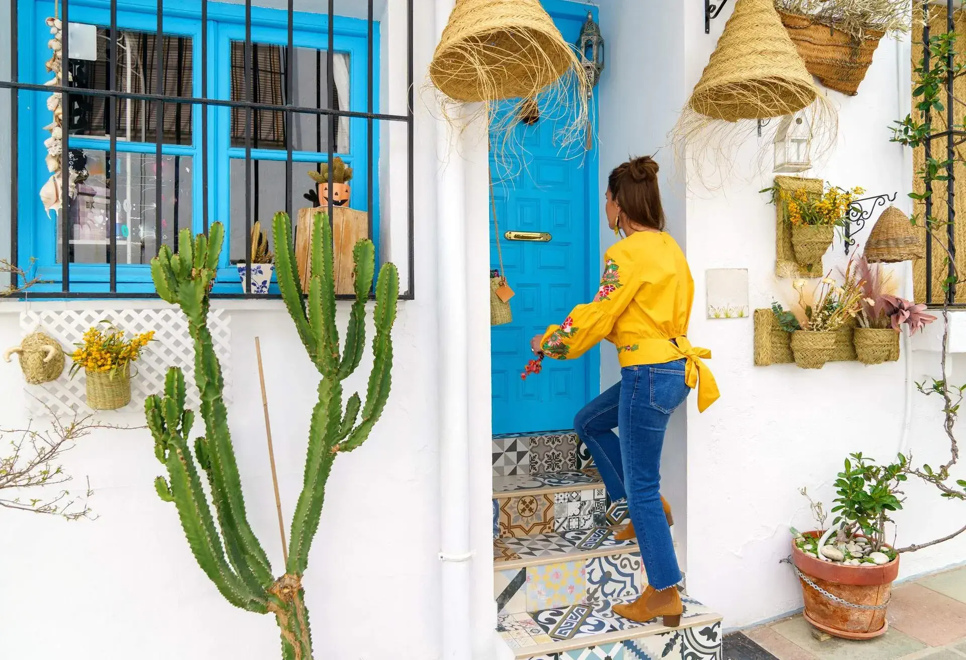 Rear view of a millennial woman opening the door of her small store