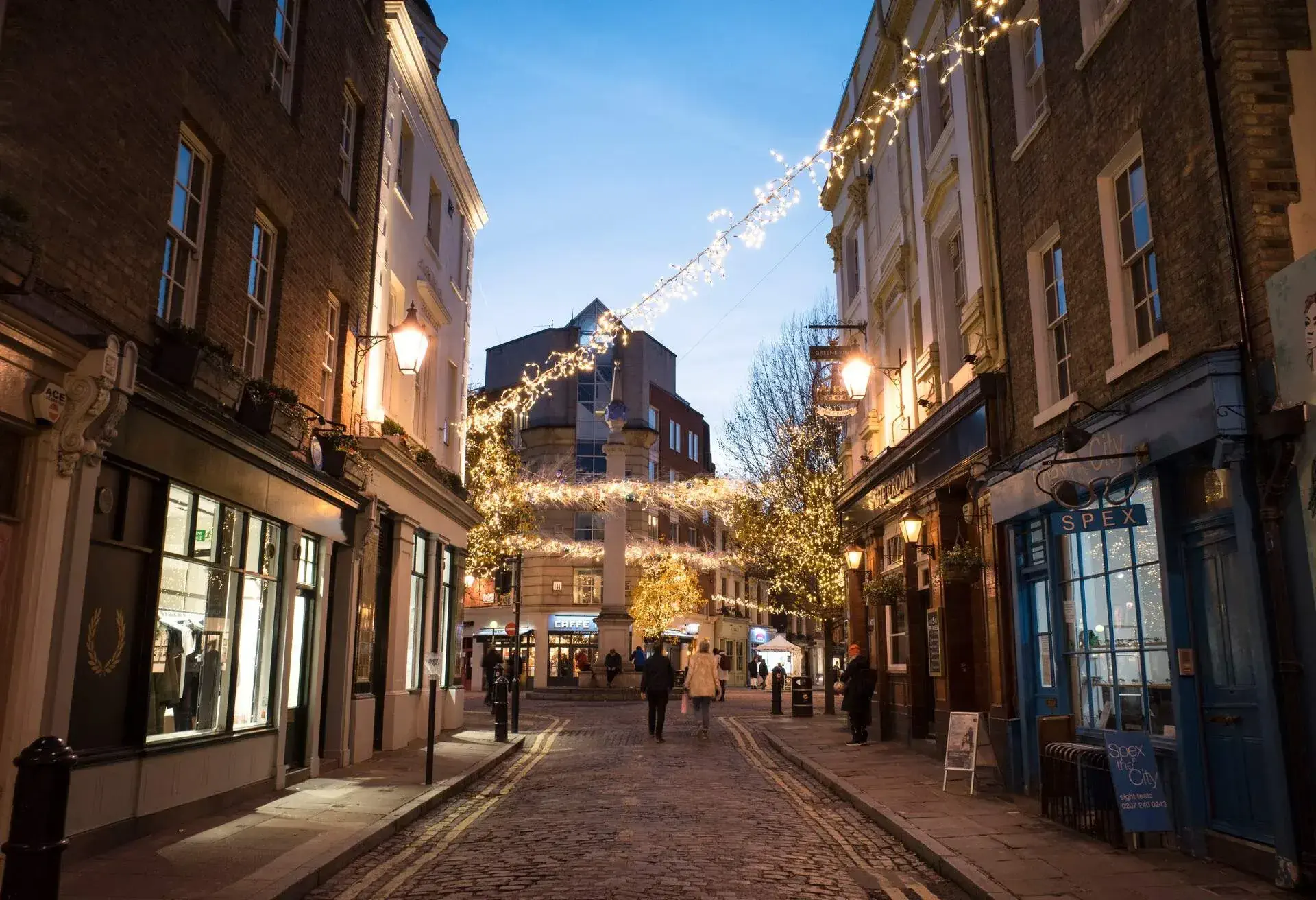 Street view at Seven Dials in the St Giles district of the London Borough of Camden in London West End with Christmas lights during the holidays
