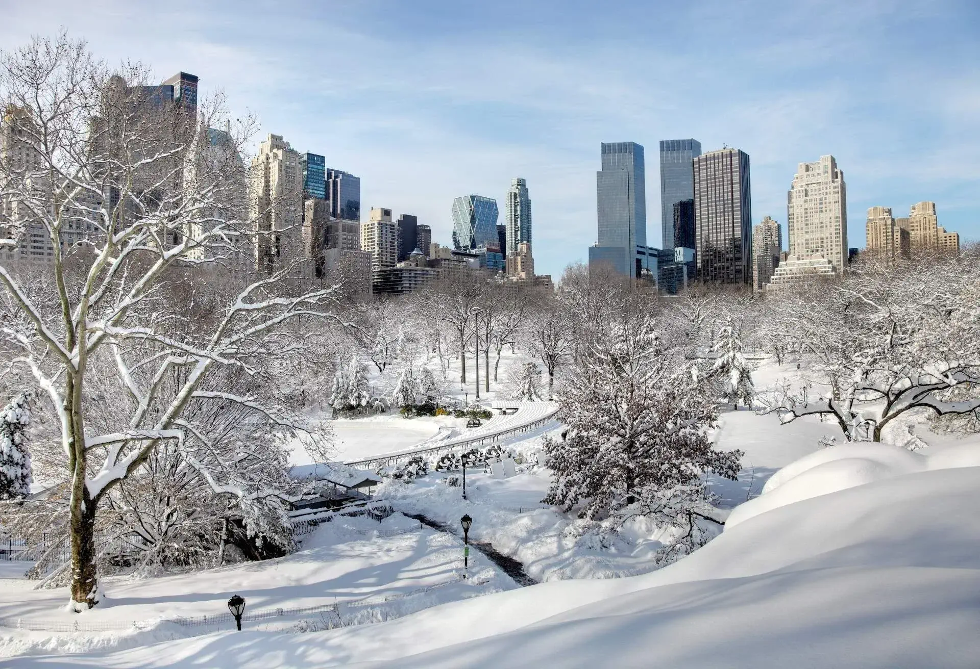 blizzard in New York City turns Central Park into a winter wonderland. Photo taken from a scenic viewpoint showing the Manhatten skyline rising from the snow covered trees.