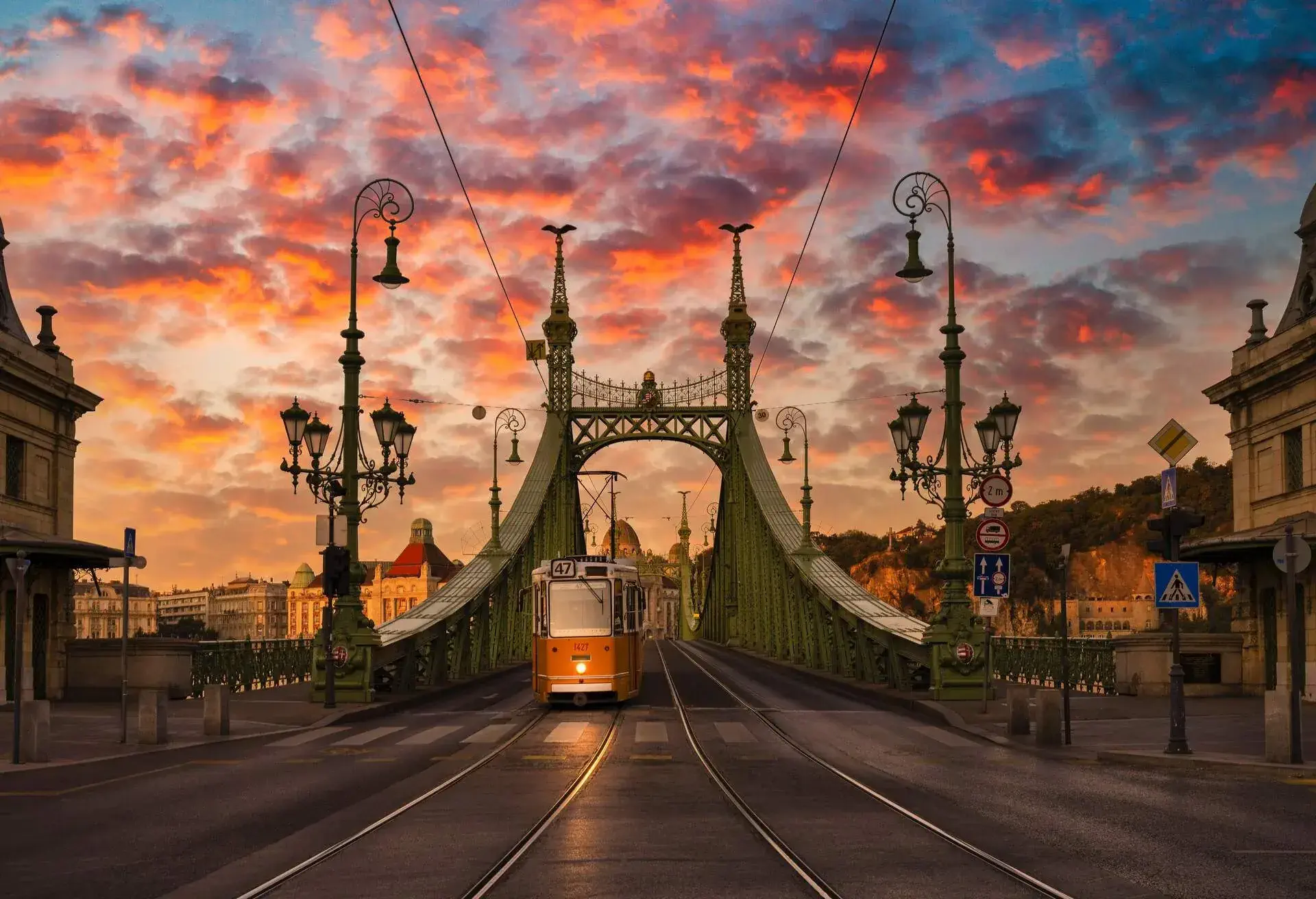Yellow tram just crossed the Danube river over the Liberty bridge at Beautiful Sunrise in Budapest