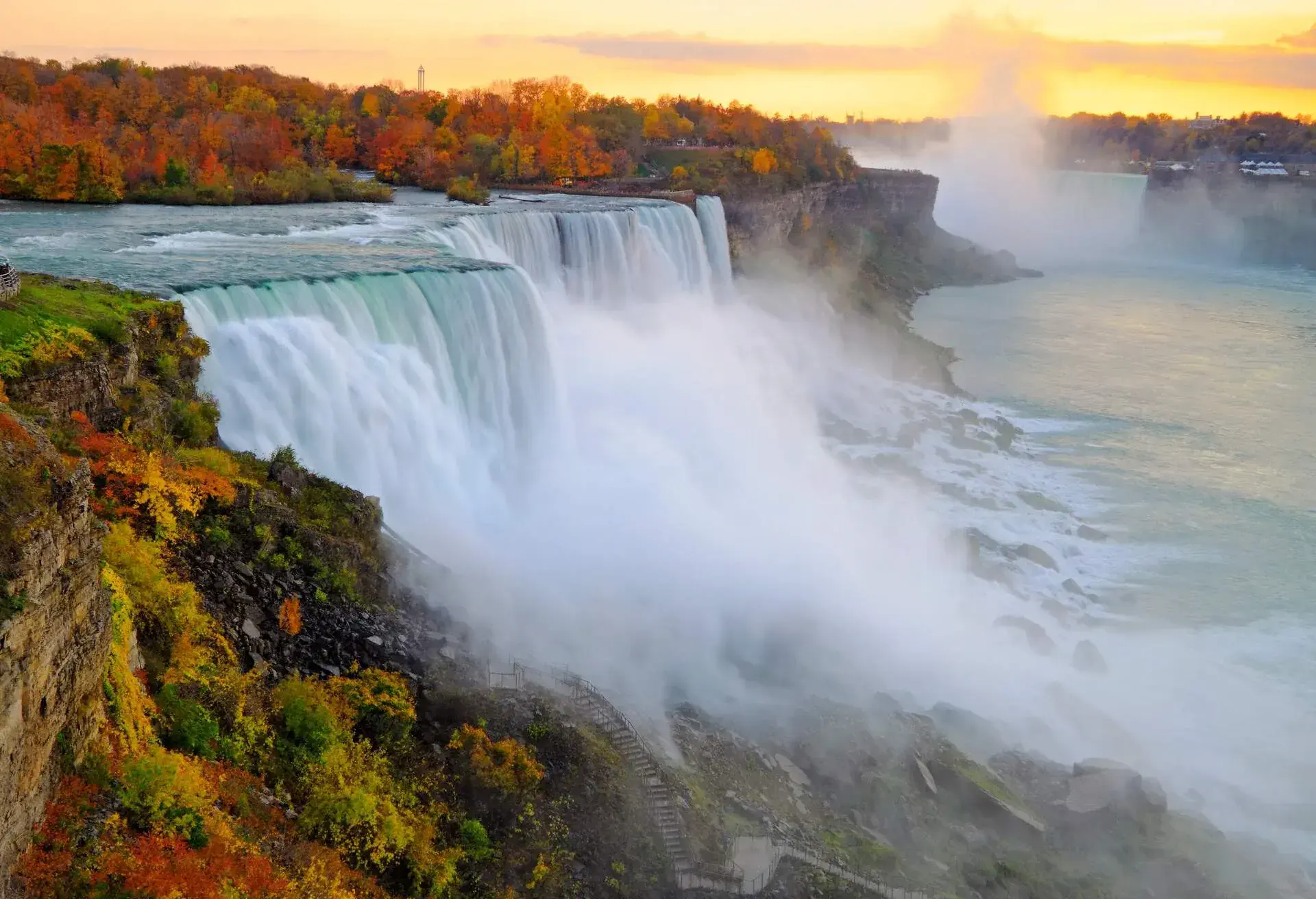 Water rushing over the Niagara Falls producing an intense mist.