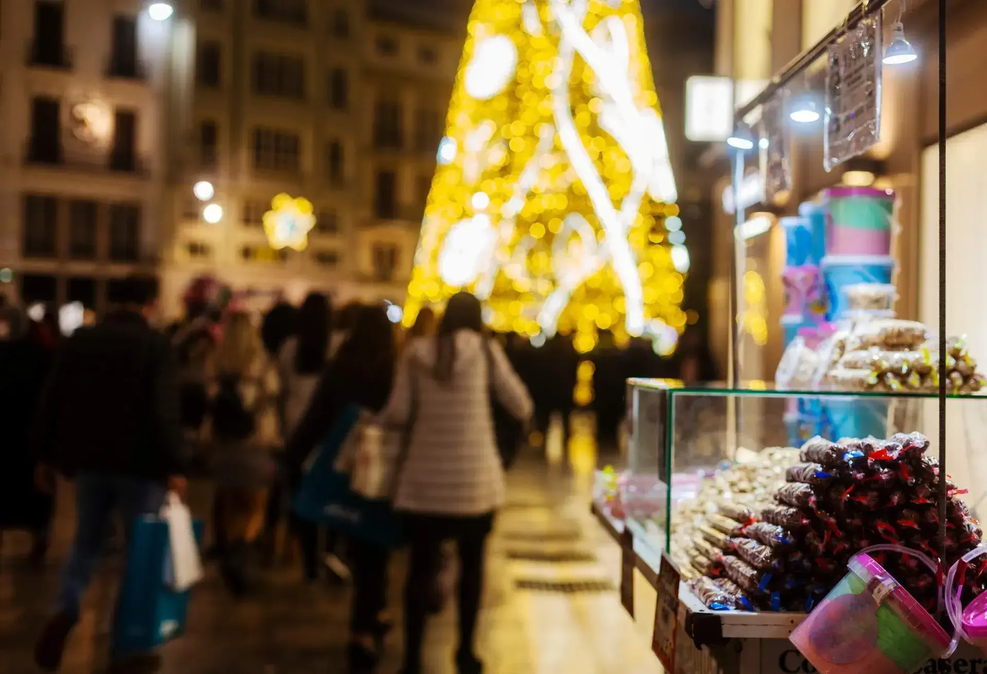 In the background the giant Christmas tree and people shopping. In time of coronavirus. Christmas 2020 in Malaga. Andalusia. Spain