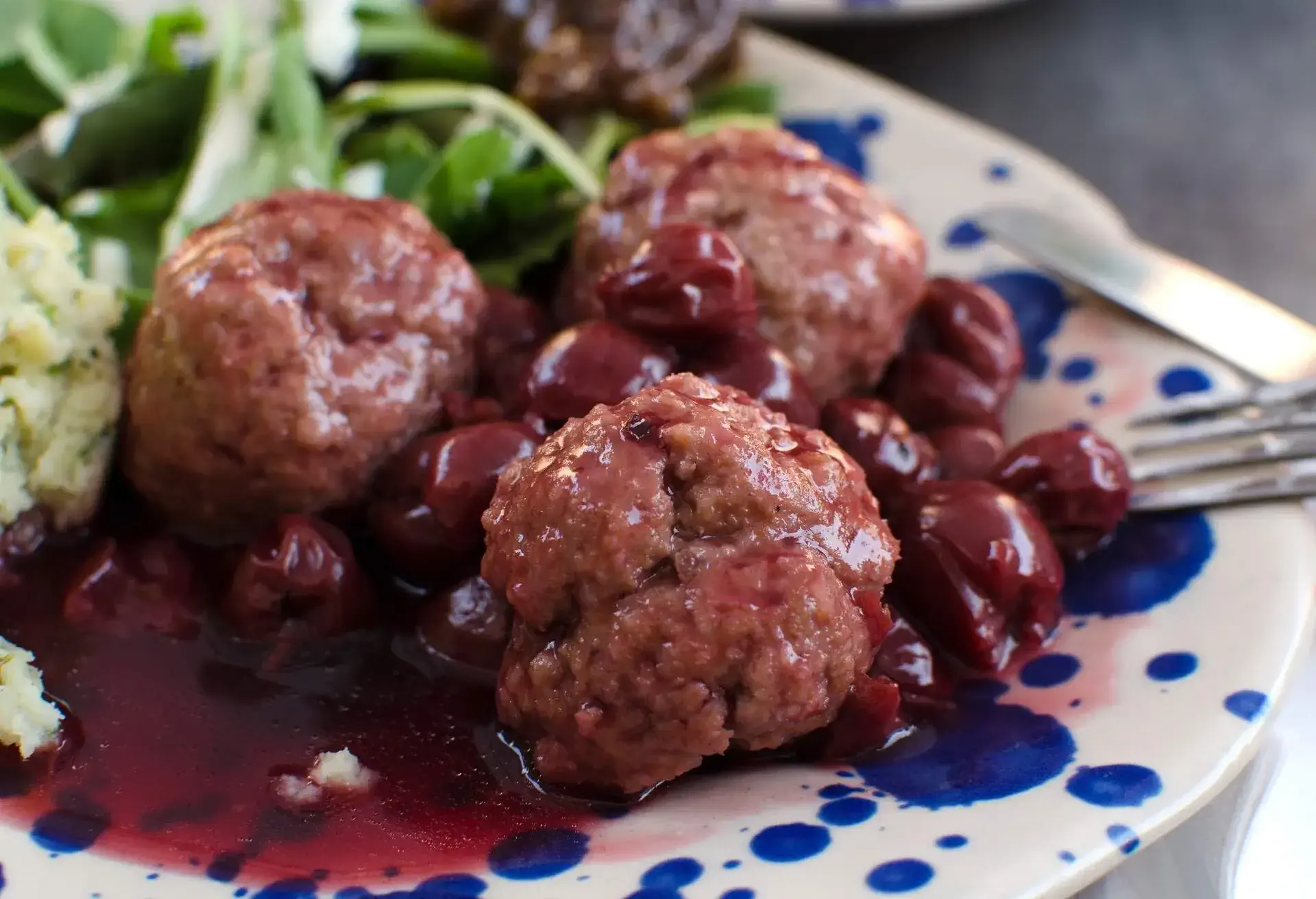 le boulet with cherry sauce and mash and herb on the plate, tipic belgium plate